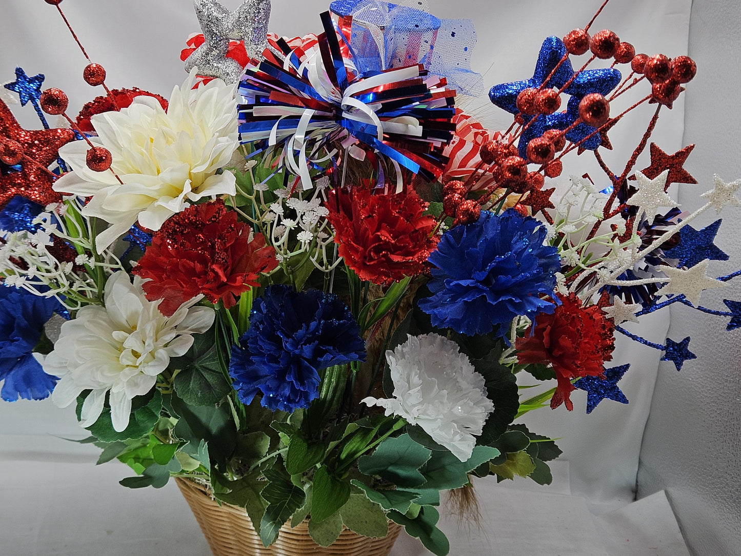 Stuffed Patriotic Steer Celebrating the USA within a Garden of Red/White/Blue Roses/Carnations/Greenery/Sparkly Stars/Other Glitter Accents