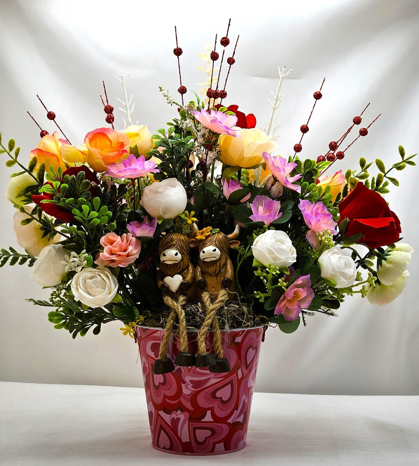 Adorable Cow Couple, Cuddled together and Sitting in a Rose and Glitter Accented Garden, And all Set in a Heart-dorated Pail, Great Romance