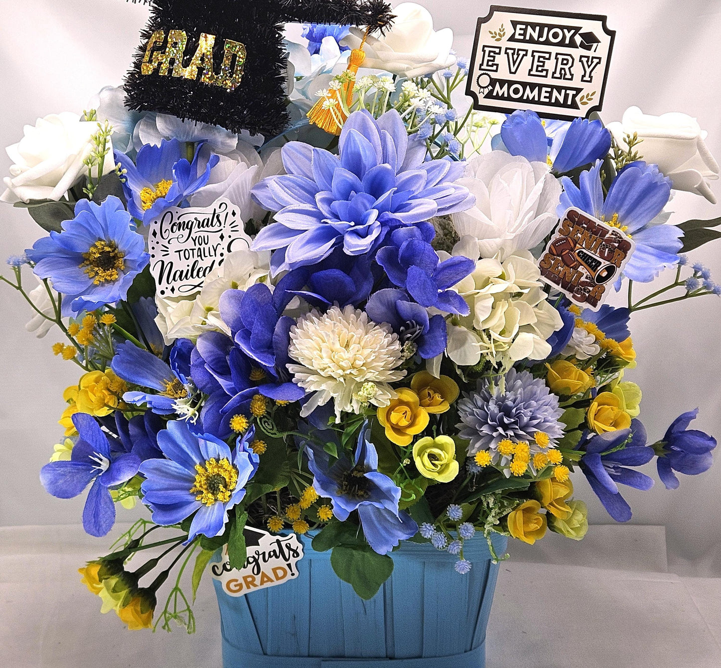 Graduation Floral Centerpiece/Blue Wood Basket/Blue/White/Yellow Flowers/Graduation Hat/Congratulations Messages/Roses/Dahlias/Pansies Plus
