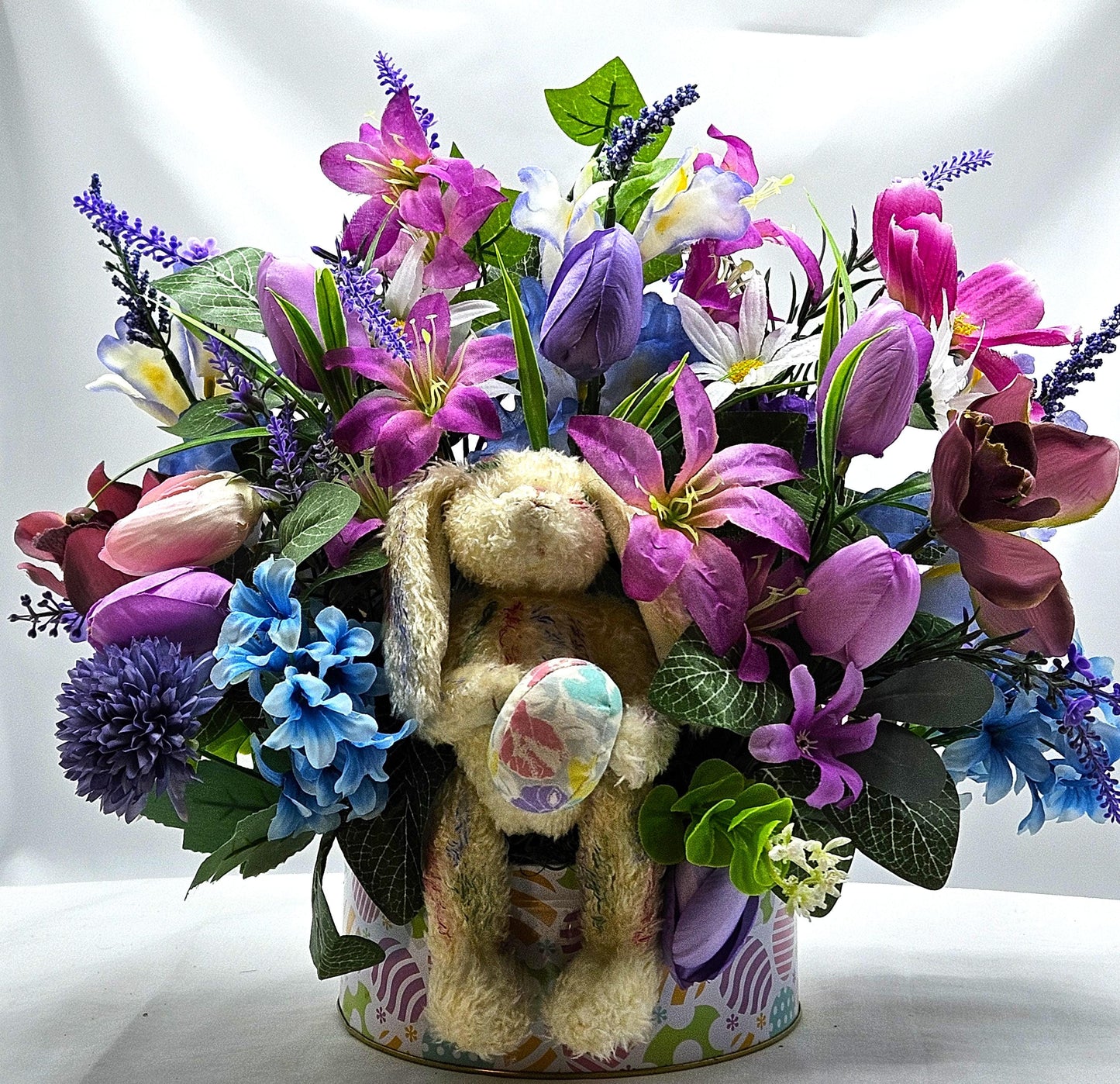Large Easter Egg Tin with Vintage Rabbit Holding an Egg and Sitting amidst Purple/Lilac Lilies/Tulips and Blue Hyacinths