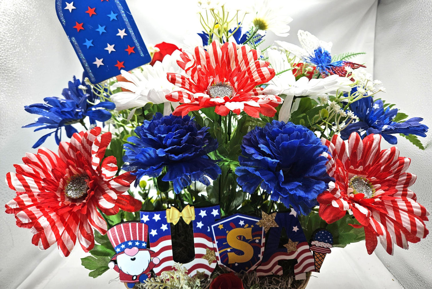Gnome in the USA Patriotic Flower Arrangement, Oval Wicker Basket, Red White Blue Daisies, Sunflowers, Carnations