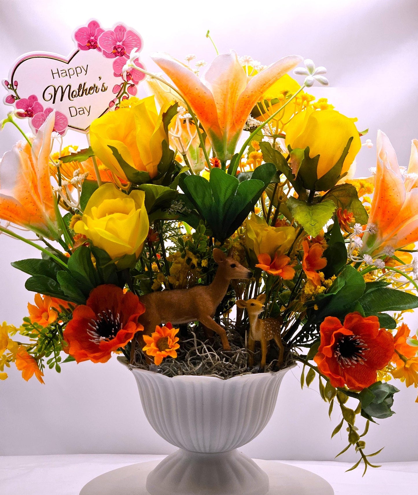 Momma and baby deer frolicking in a floral garden of yellow and orange Lilies, Pansies, Roses/other Florals, Greenery/Baby's Breath/Gifting