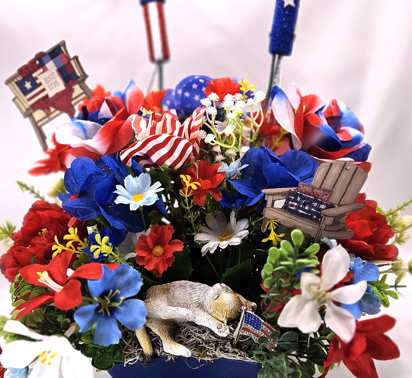 Patriotic Cat Floral Arrangement – Belly-Up Kitten or Lying Cat in Star Dish with Red White Blue Flowers
