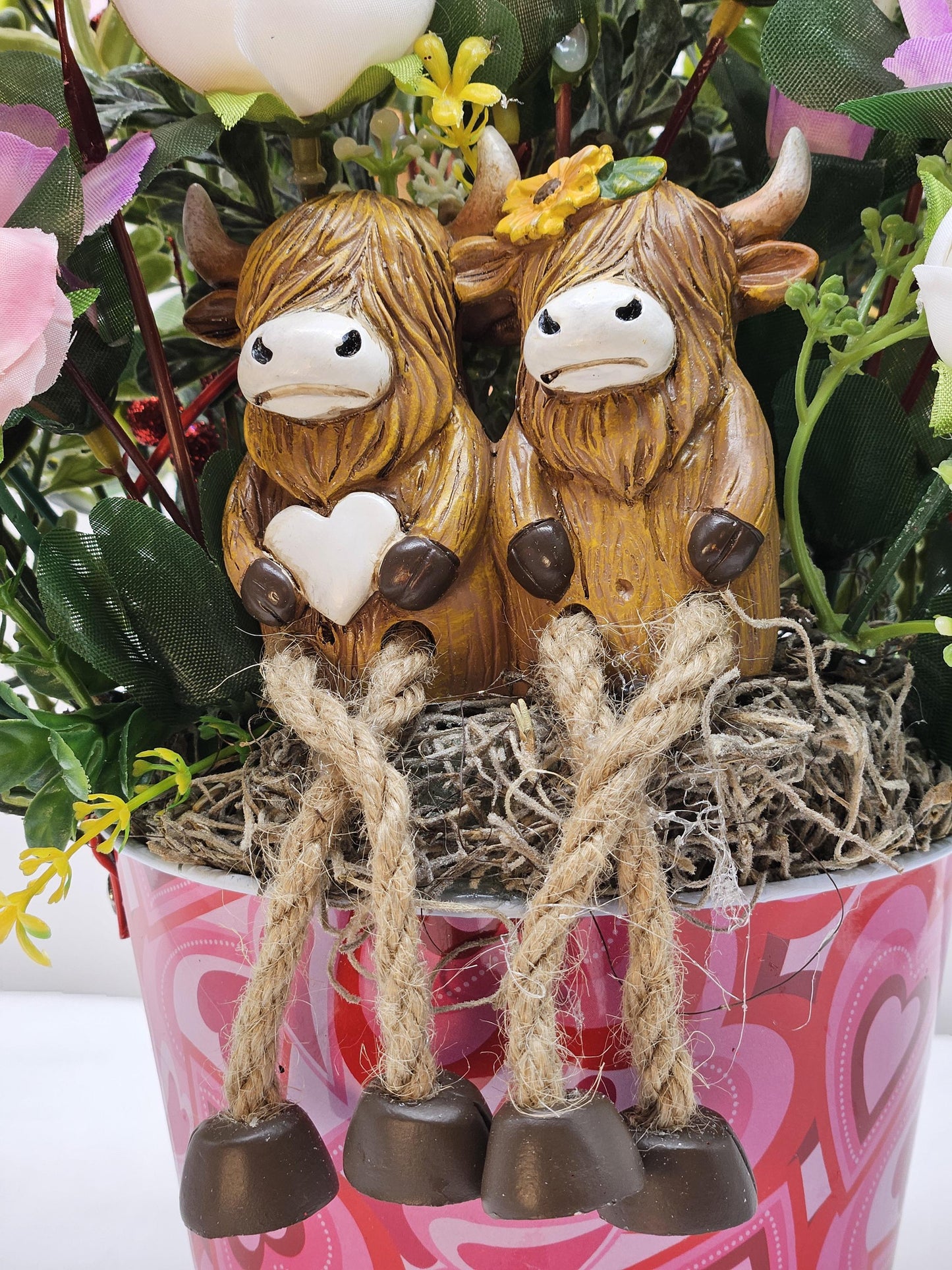 Adorable Cow Couple, Cuddled together and Sitting in a Rose and Glitter Accented Garden, And all Set in a Heart-dorated Pail, Great Romance