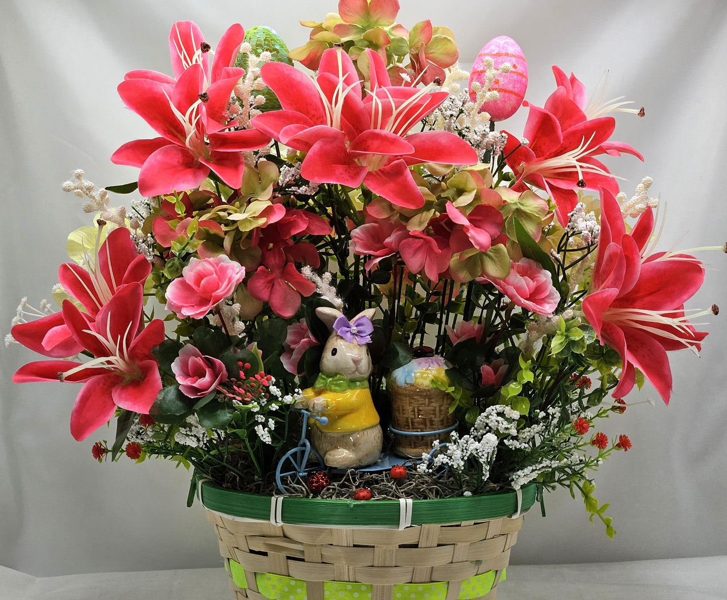 Whimsical Easter Basket/Rabbit in Bike Carrying Goodies/Accented W/cute Ladybugs/Hot Pink Lilies/Other florals/pink/green/Greens/Baby Breath