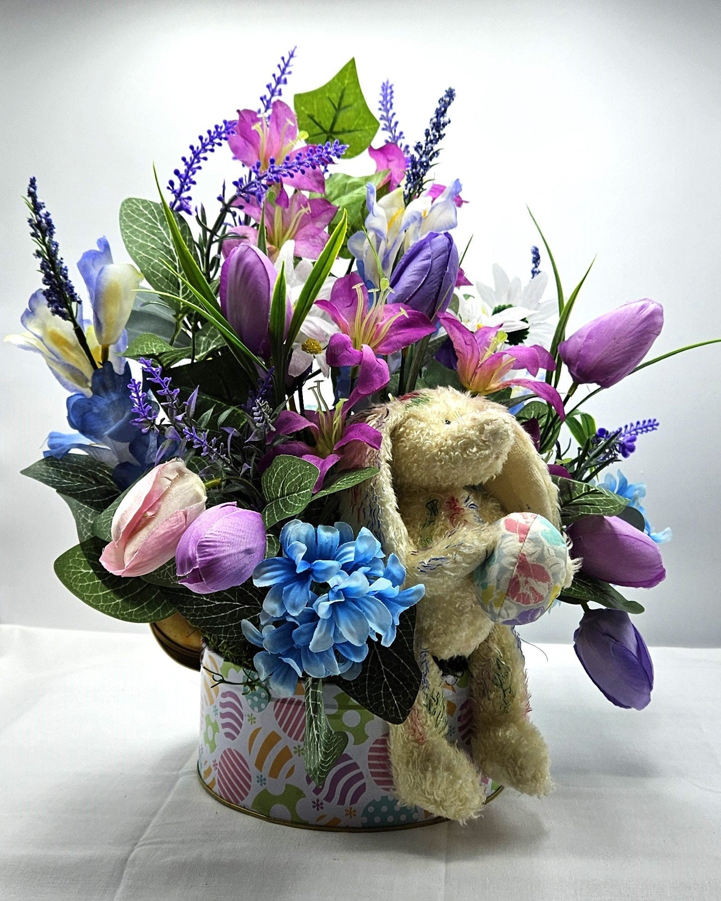 Large Easter Egg Tin with Vintage Rabbit Holding an Egg and Sitting amidst Purple/Lilac Lilies/Tulips and Blue Hyacinths