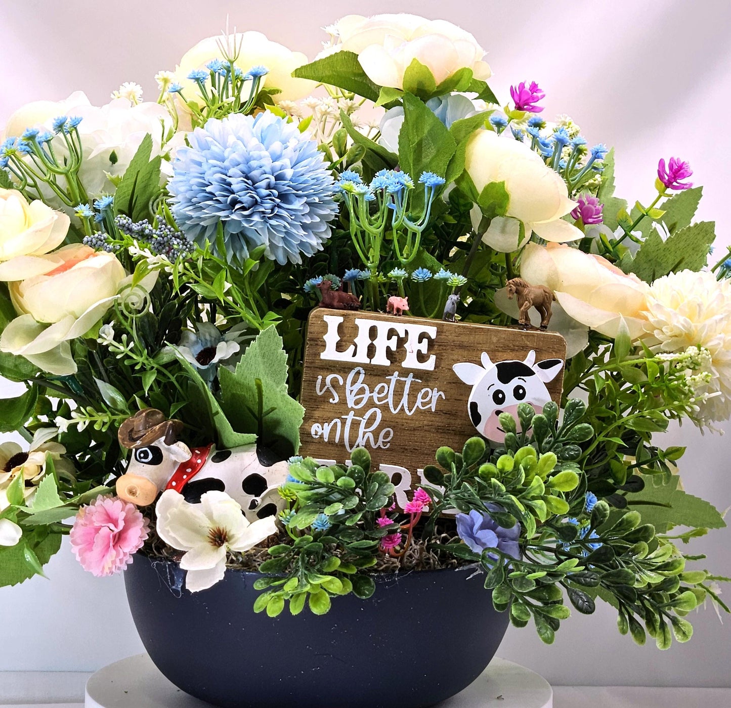 Life is Better on the Farm Floral Centerpiece w/Country Cow, Curious Sign and Various Farm Farm Animals Amidst Ranunculus/Other Flowers