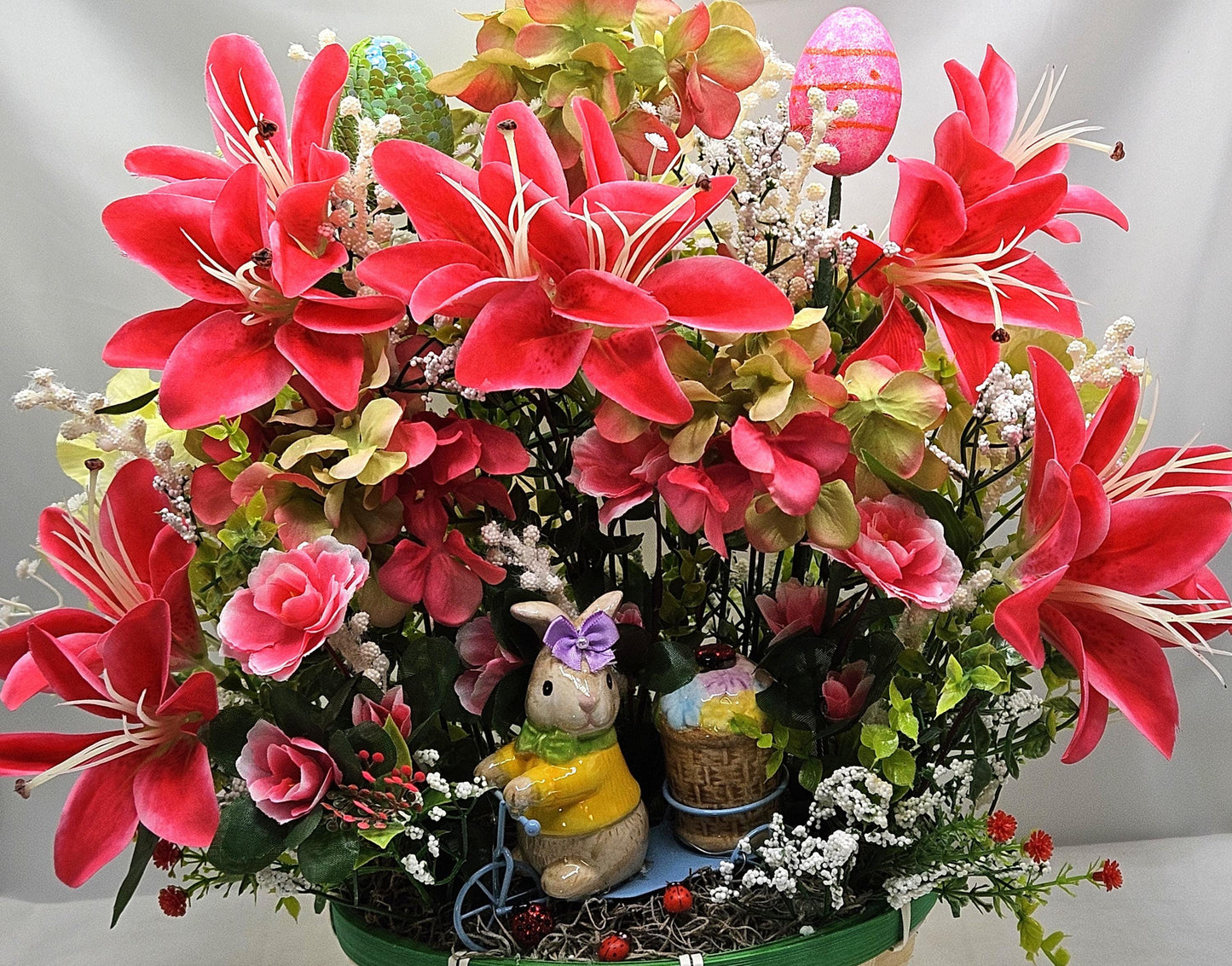 Whimsical Easter Basket/Rabbit in Bike Carrying Goodies/Accented W/cute Ladybugs/Hot Pink Lilies/Other florals/pink/green/Greens/Baby Breath