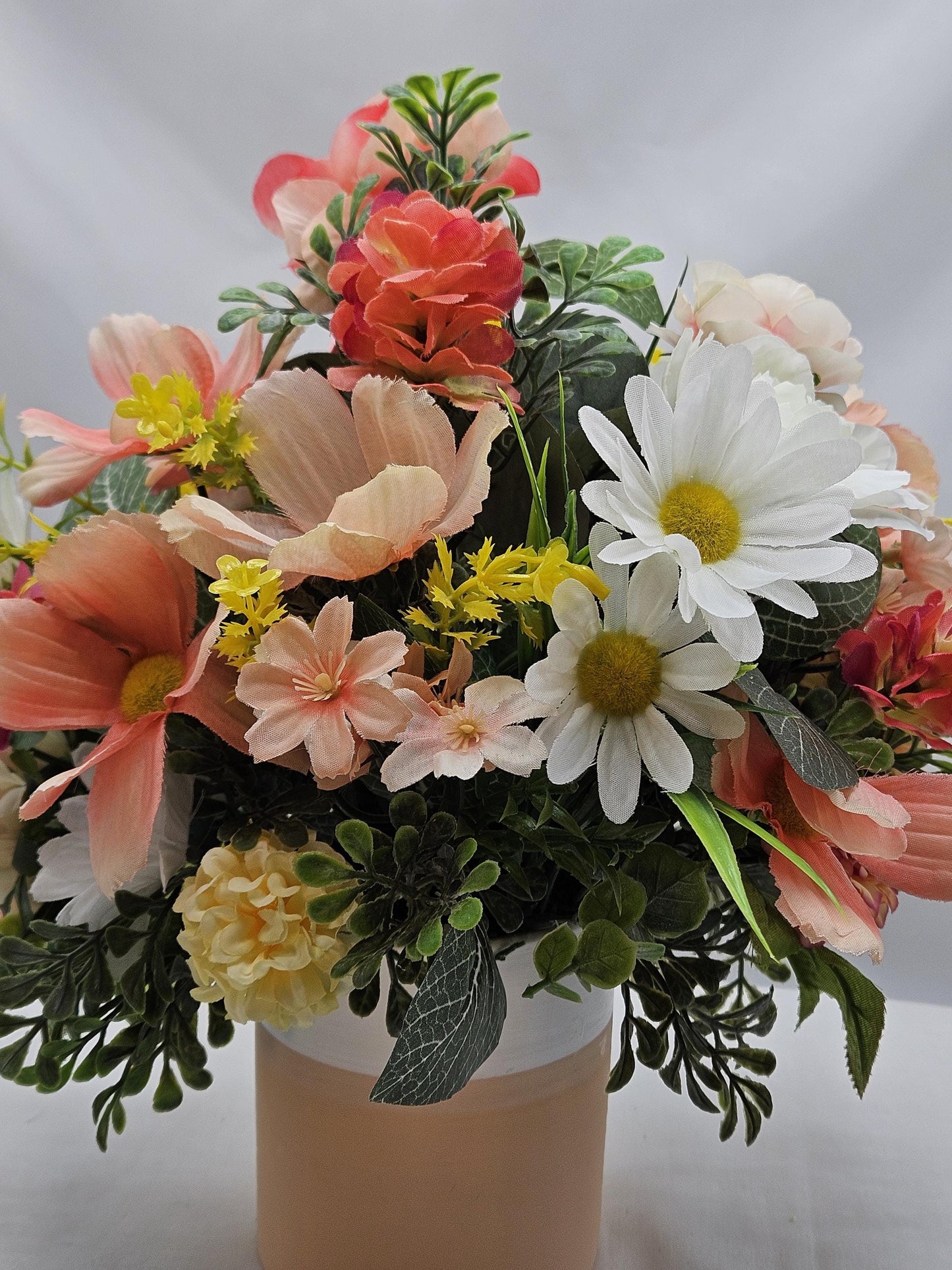 Ceramic Bunnies in a Pink/Peach/Yellow Flower Garden, Lush Greens and Baby's Breath, All Nestled in a Two Tone Ceramic Beige/White Vase
