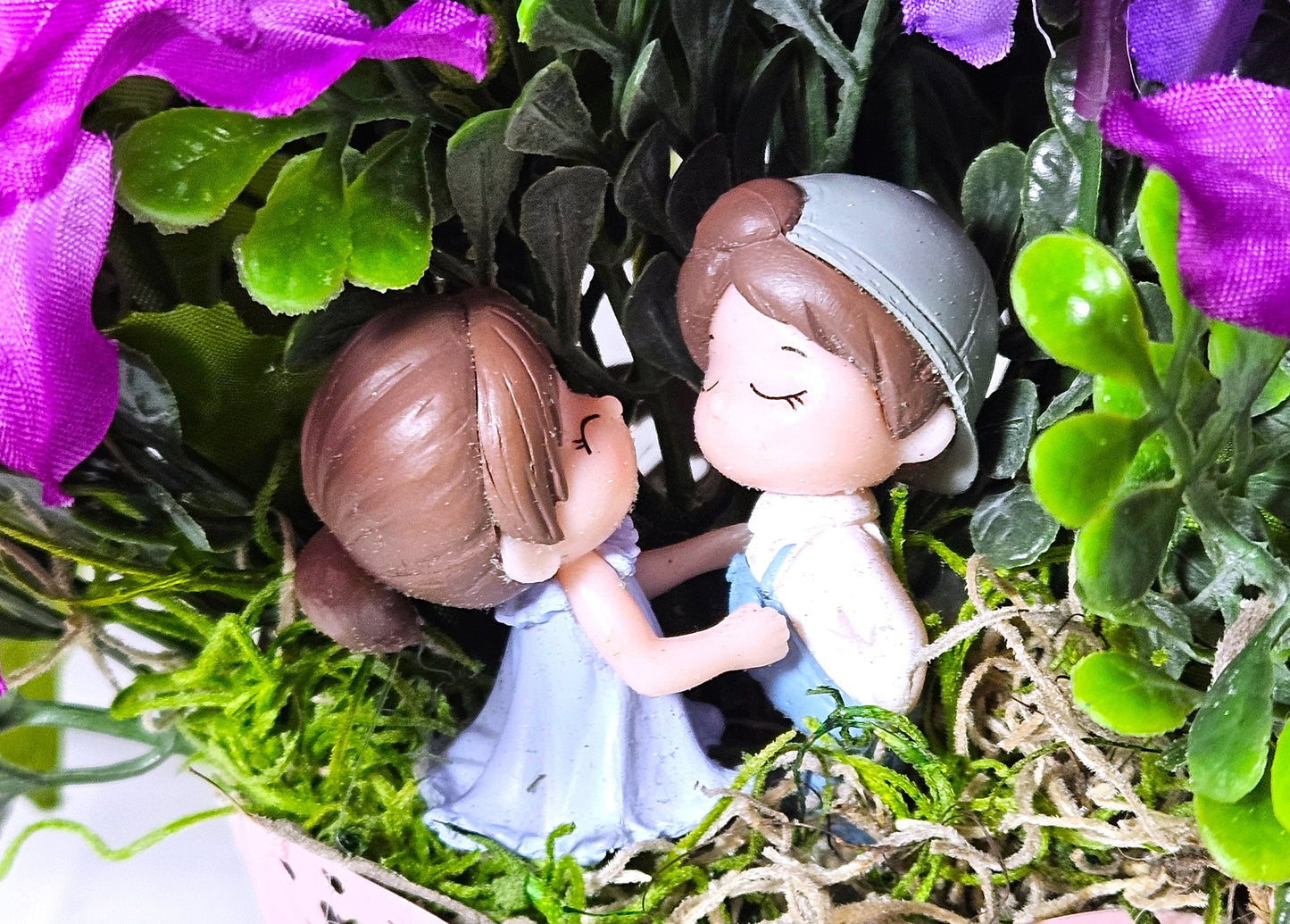 Heartwarming Flower Arrangement with a Kissing Couple Among Blue, Lilac, and Pink Florals Plus Sparkly Hearts