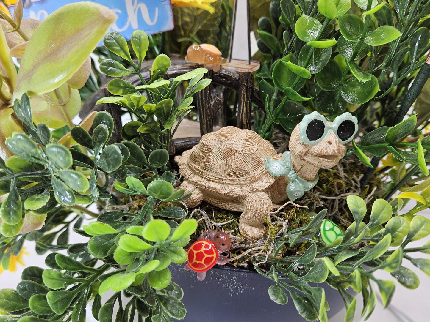 Fun in the Sun Turtle Mania Tropical Flower Arrangement/Turtle in Sunglasses in garden of Teal/Yellow/Green Flowers/Greenery/Bridge