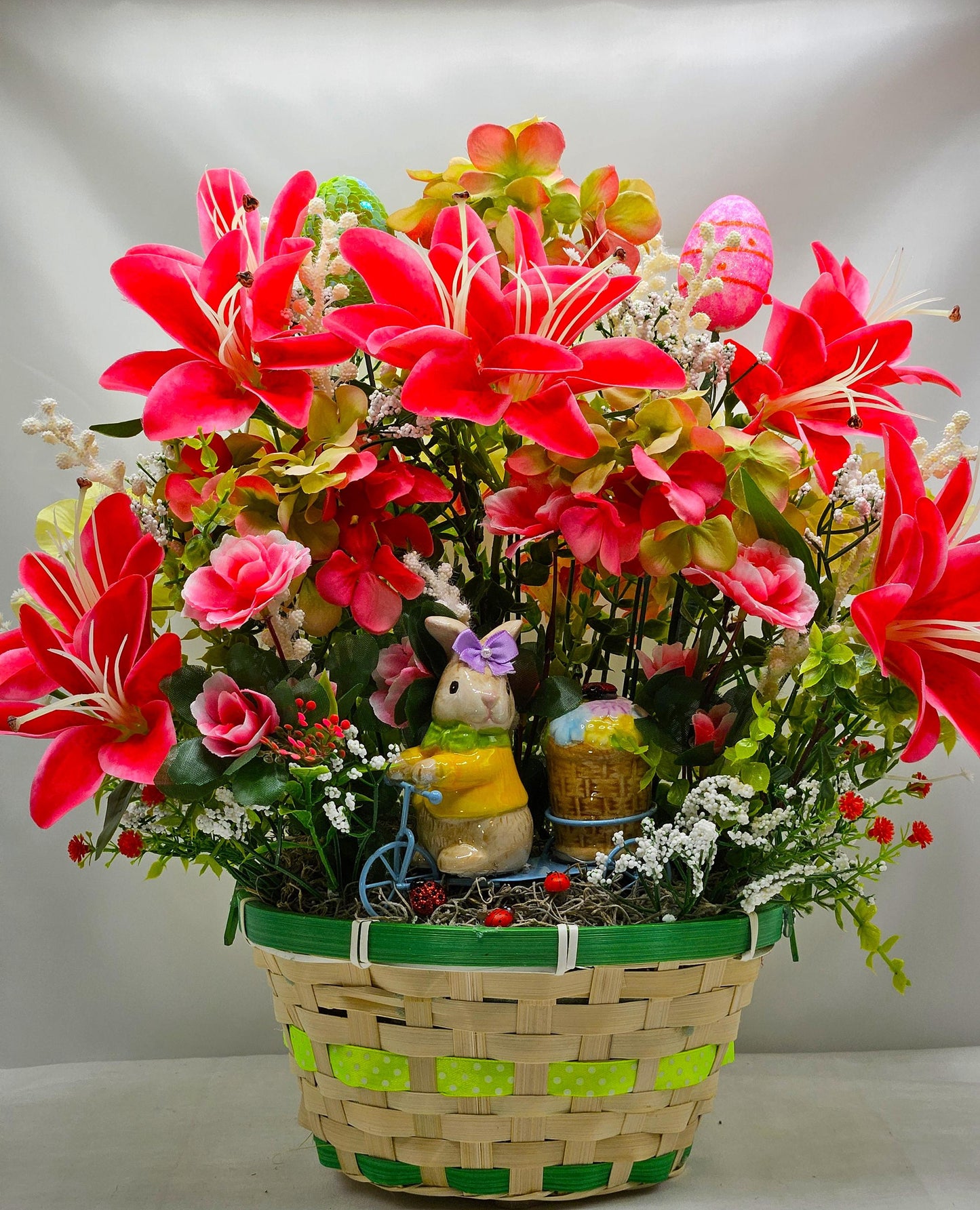 Whimsical Easter Basket/Rabbit in Bike Carrying Goodies/Accented W/cute Ladybugs/Hot Pink Lilies/Other florals/pink/green/Greens/Baby Breath
