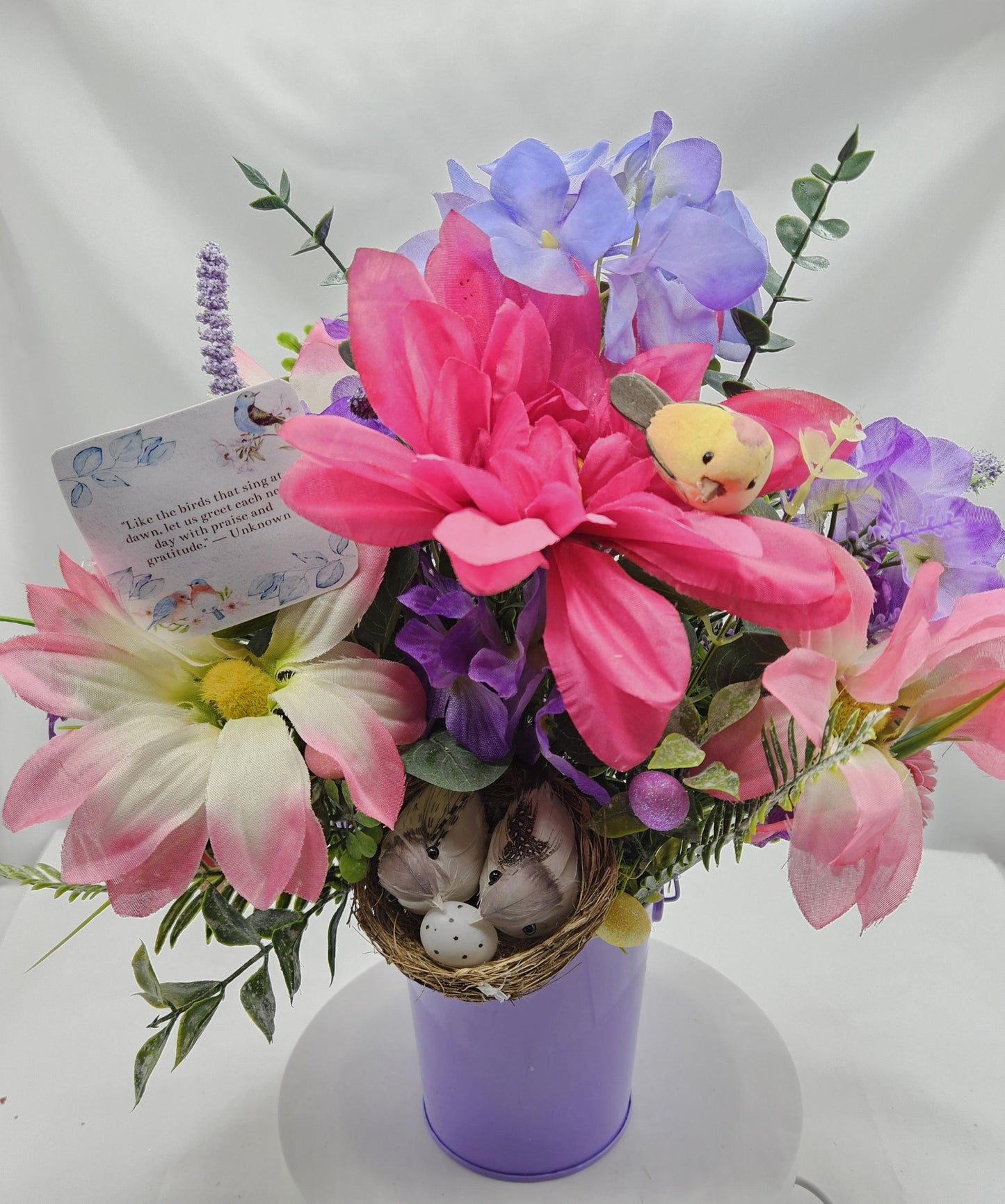 Charming Thinking Of You Bouquet set in a light purple container and accented with birds in a nest and/Atop Flowers/Pink/White/Blue/Greenery
