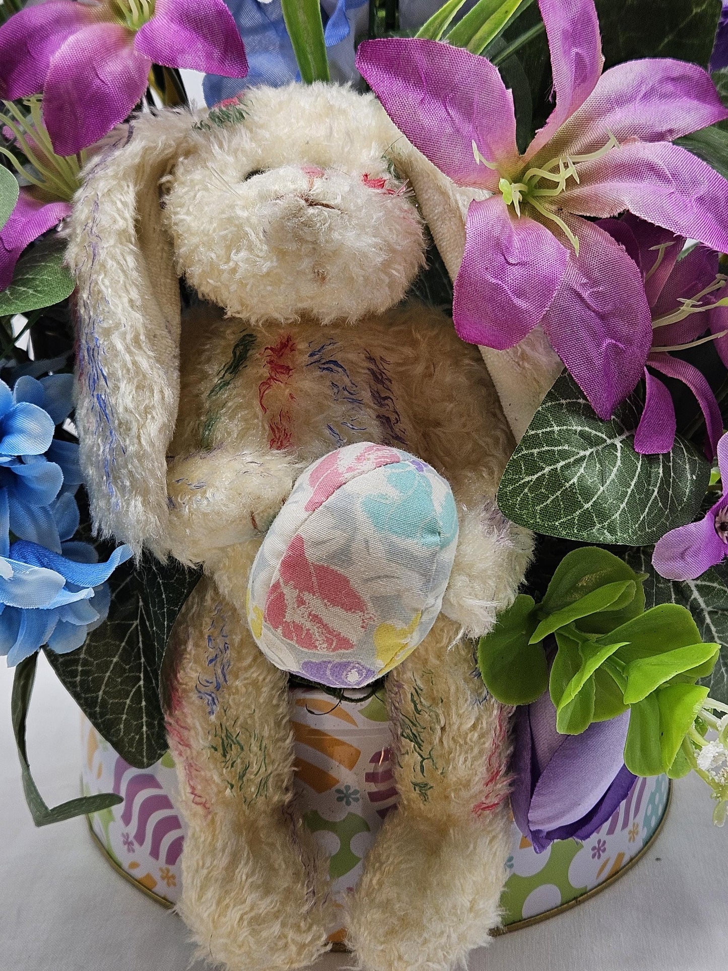 Large Easter Egg Tin with Vintage Rabbit Holding an Egg and Sitting amidst Purple/Lilac Lilies/Tulips and Blue Hyacinths