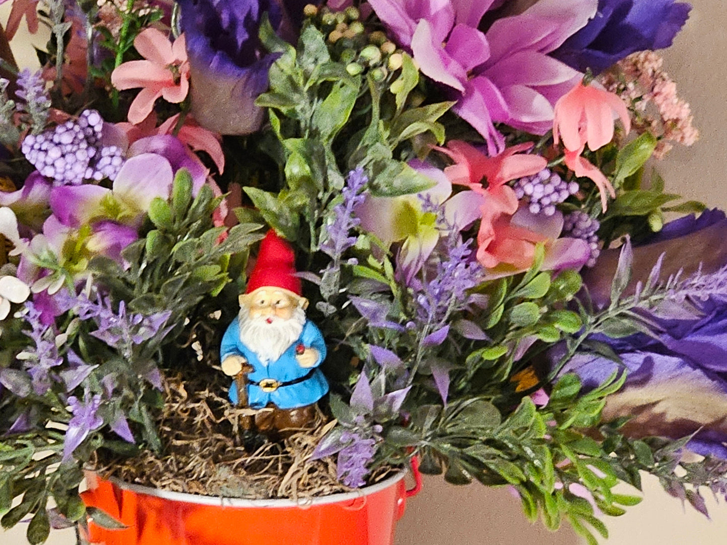 Artificial Floral Arrangement in Round Red Bucket with Gnome