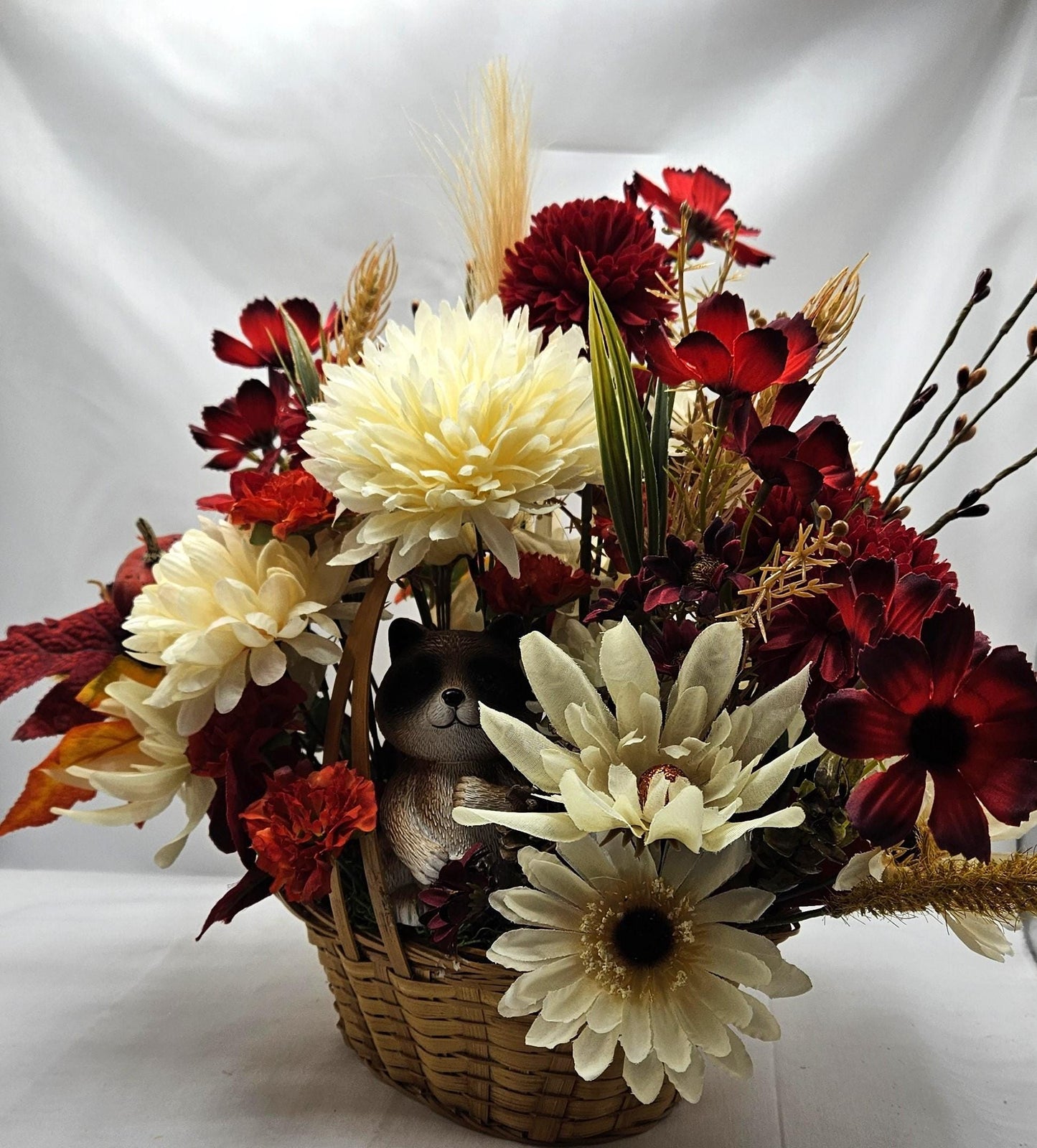 Deep Red and White Mums, Daisies, Other Wildflowers/Fall Leaves/Woodland Raccoon, Set in Handle Wicker Basket, Fall/Autumn Accents
