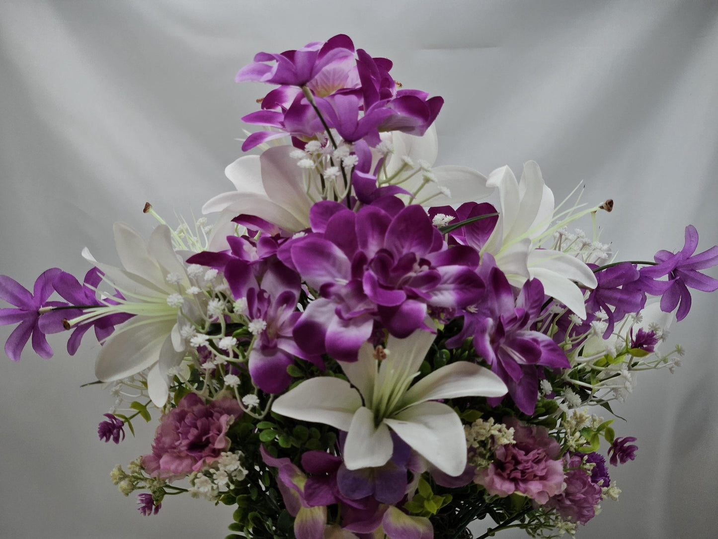 Amazing Grace Elegant Floral Arrangement Featuring a White Wooden Cross Nestled Amidst a Garden of White Lilies/Purple Orchids/wicker Basket