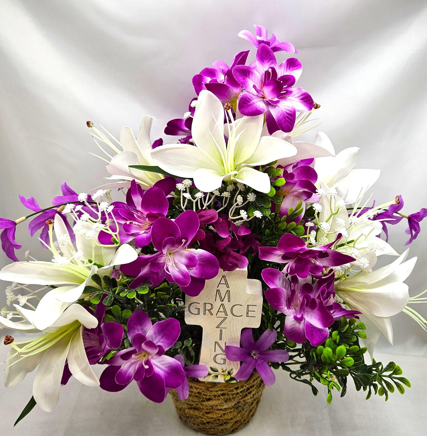 Amazing Grace Elegant Floral Arrangement Featuring a White Wooden Cross Nestled Amidst a Garden of White Lilies/Purple Orchids/wicker Basket