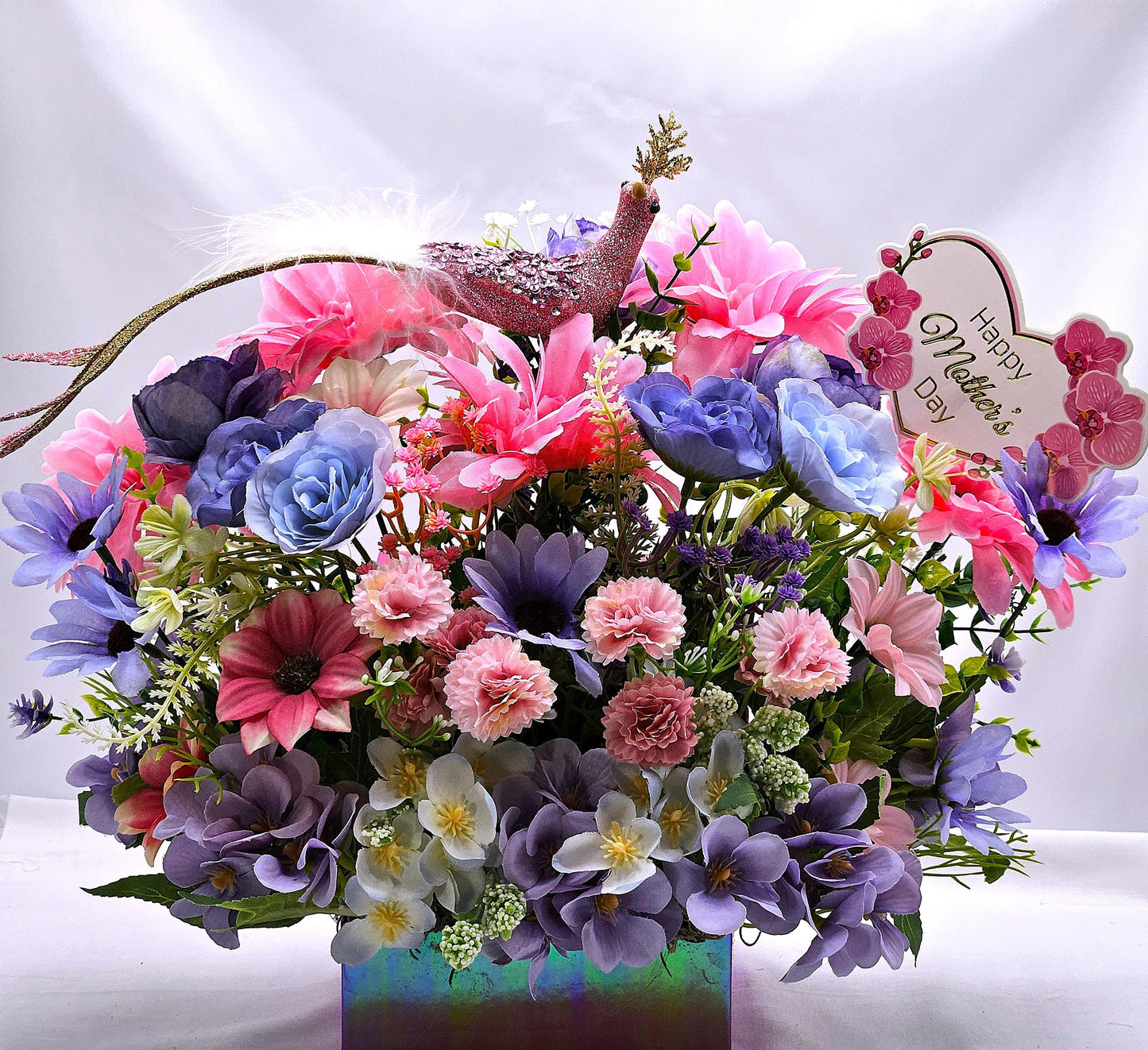 Pastel Pearlized Gift Box Filled with Vibrant/Lush Purple/Pink/White Flowers/Greenery/Baby's Breath/Sparkly Elegant Bird Atop the Florals
