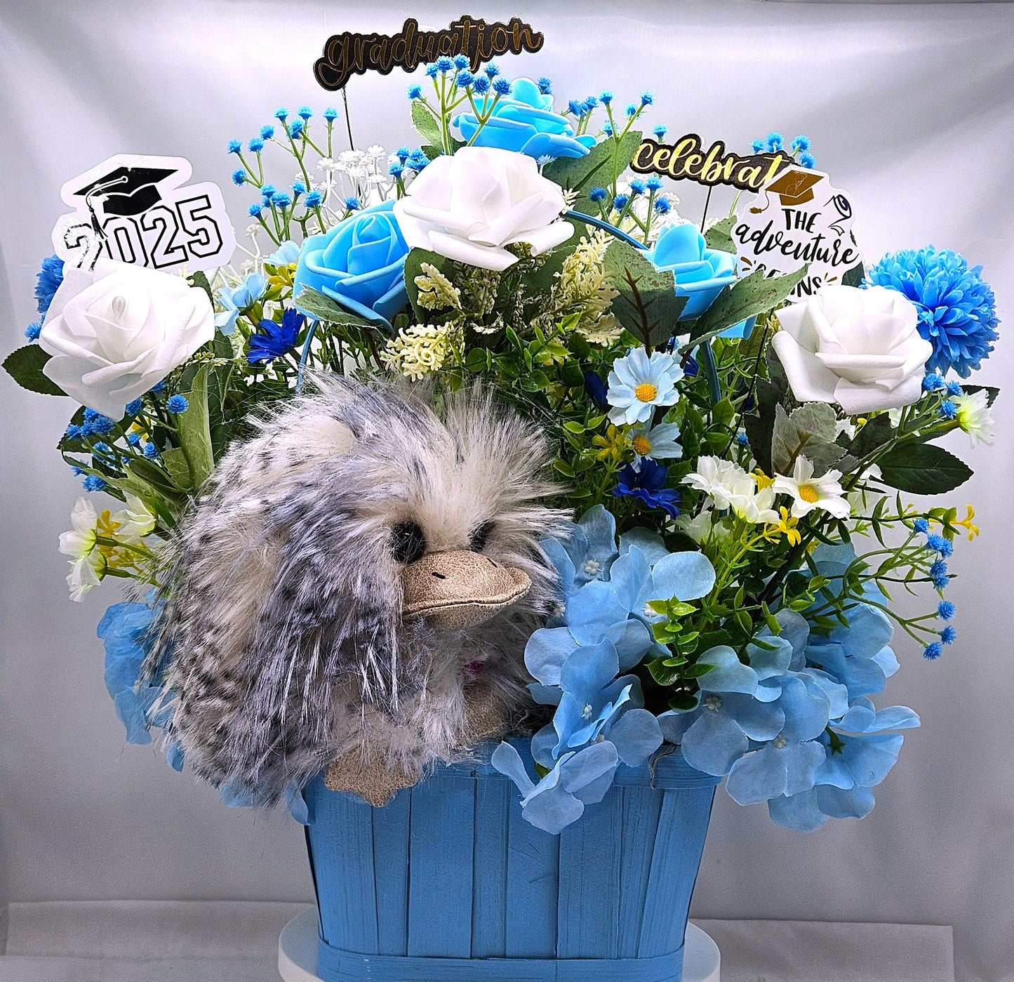 Elegant Silk-type Graduation Florals/Greenery with Unique Fuzzy Owl/Hedgehog/Platypus Accents/Wood Baskets/Blues/Yellow/Green Flowers