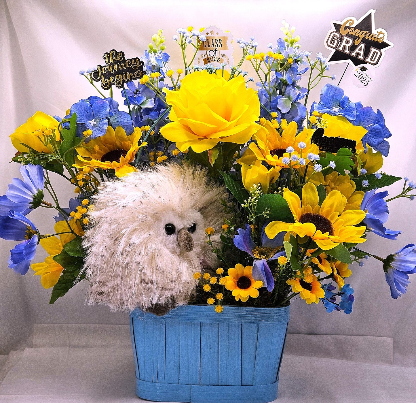 Elegant Silk-type Graduation Florals/Greenery with Unique Fuzzy Owl/Hedgehog/Platypus Accents/Wood Baskets/Blues/Yellow/Green Flowers