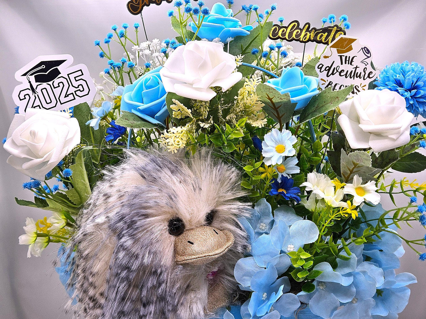 Elegant Silk-type Graduation Florals/Greenery with Unique Fuzzy Owl/Hedgehog/Platypus Accents/Wood Baskets/Blues/Yellow/Green Flowers