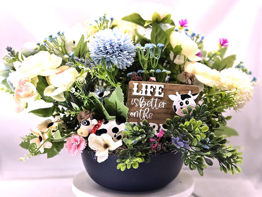 Life is Better on the Farm Floral Centerpiece w/Country Cow, Curious Sign and Various Farm Farm Animals Amidst Ranunculus/Other Flowers