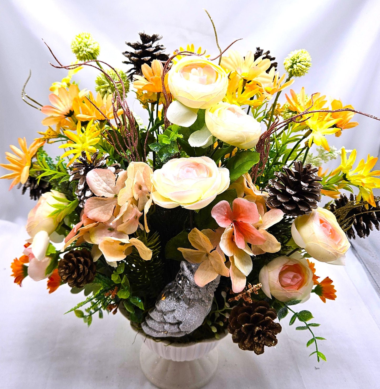 Striking Floral Centerpiece Featuring a Stunning Crystal-Look Majestic Owl Amidst a Garden of Multi-Colored WildflowersGreenery/PineCones
