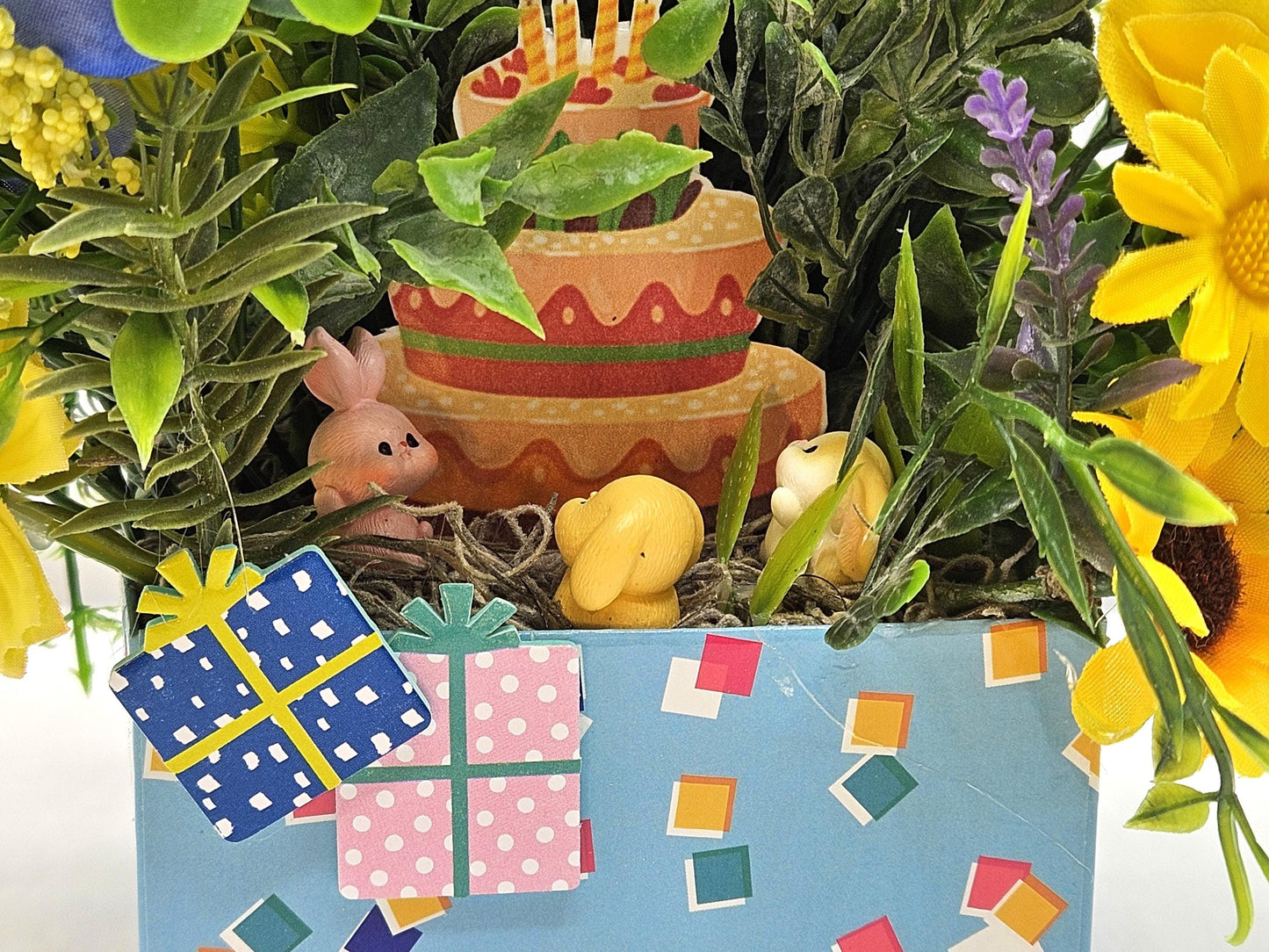Birthday Flower Arrangement set in Blue Gift Box, Glittery BD Cake on the Lid, Lovely Blue/Yellow Blooms, Cute Bunnies, Baloons, Gifts