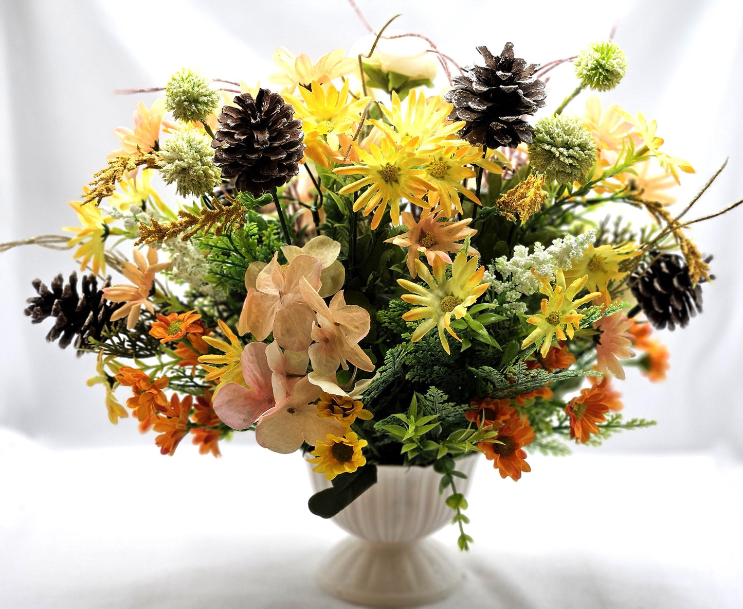 Striking Floral Centerpiece Featuring a Stunning Crystal-Look Majestic Owl Amidst a Garden of Multi-Colored WildflowersGreenery/PineCones