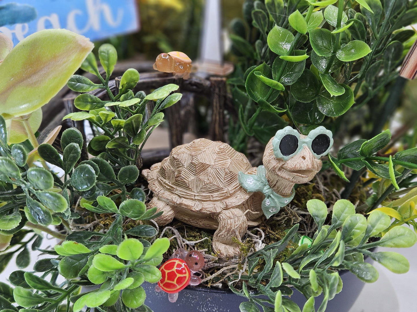 Fun in the Sun Turtle Mania Tropical Flower Arrangement/Turtle in Sunglasses in garden of Teal/Yellow/Green Flowers/Greenery/Bridge