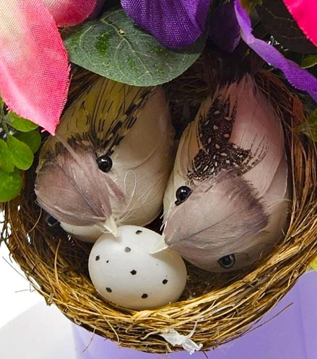 Charming Thinking Of You Bouquet set in a light purple container and accented with birds in a nest and/Atop Flowers/Pink/White/Blue/Greenery