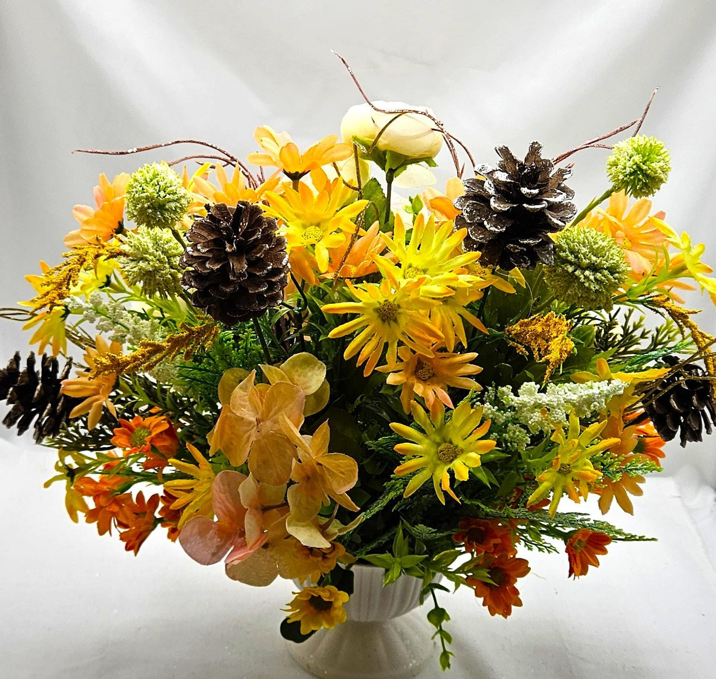 Striking Floral Centerpiece Featuring a Stunning Crystal-Look Majestic Owl Amidst a Garden of Multi-Colored WildflowersGreenery/PineCones