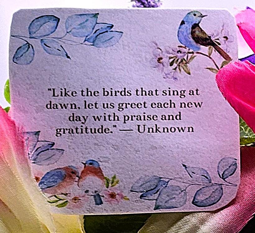 Charming Thinking Of You Bouquet set in a light purple container and accented with birds in a nest and/Atop Flowers/Pink/White/Blue/Greenery