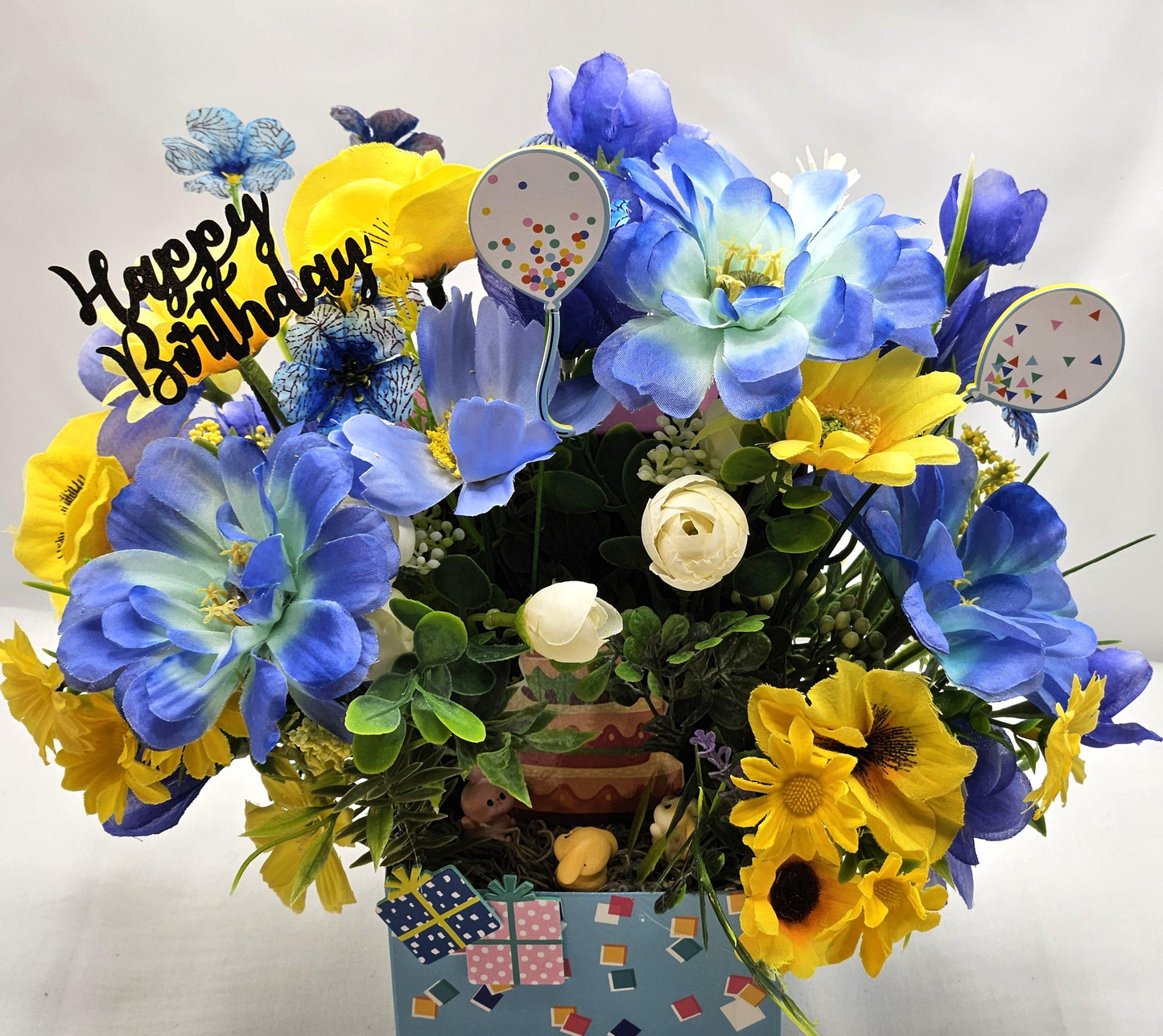 Birthday Flower Arrangement set in Blue Gift Box, Glittery BD Cake on the Lid, Lovely Blue/Yellow Blooms, Cute Bunnies, Baloons, Gifts