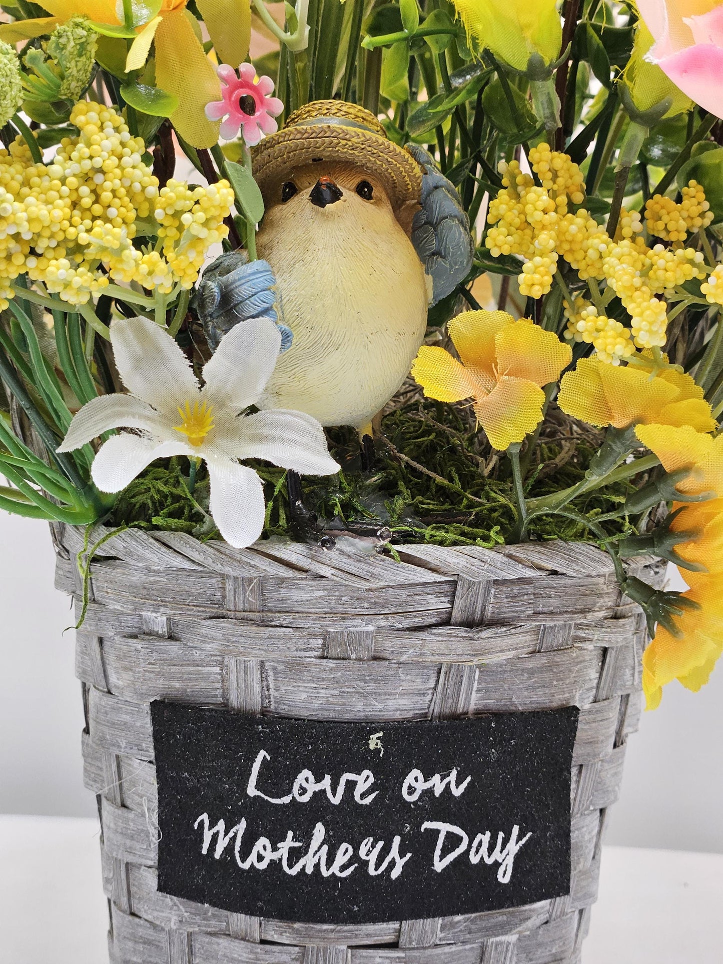 Mother's Day Bouquet in Wicker Type Pot/Love on Mother's Day/Featuring a Cheerful Bird in a Garden of Vibrant Yellow/Peach Flowers/Butterfly