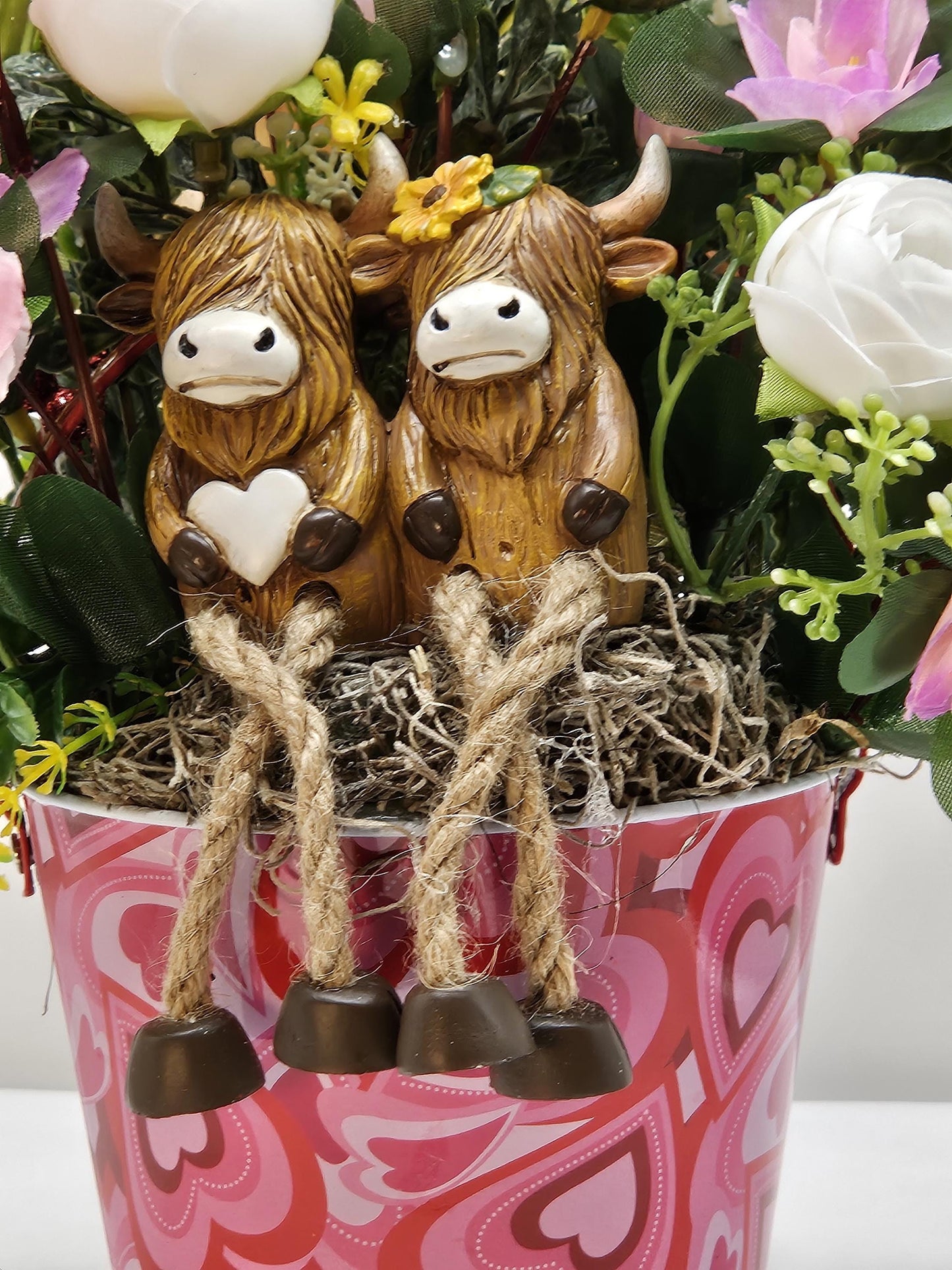 Adorable Cow Couple, Cuddled together and Sitting in a Rose and Glitter Accented Garden, And all Set in a Heart-dorated Pail, Great Romance