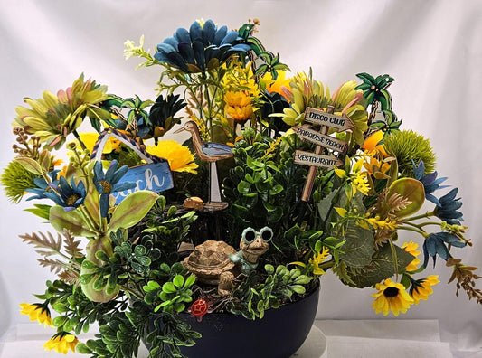 Fun in the Sun Turtle Mania Tropical Flower Arrangement/Turtle in Sunglasses in garden of Teal/Yellow/Green Flowers/Greenery/Bridge