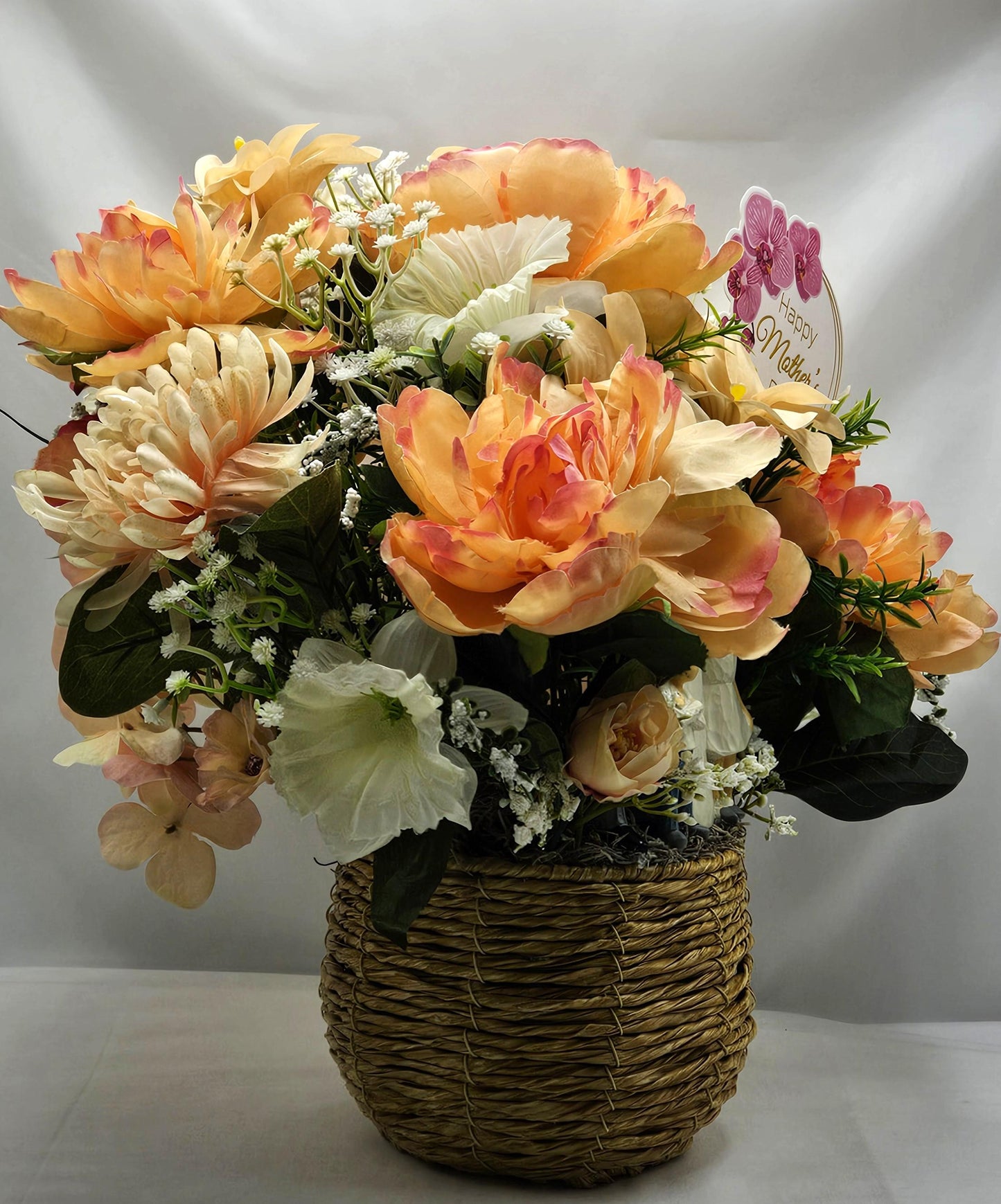 Family of Four Ceramic Figures Amidst Peach/White Flowers in Elegant Round Wicker Basket, Baby's Breath/Greenery/Mother's Day Sign