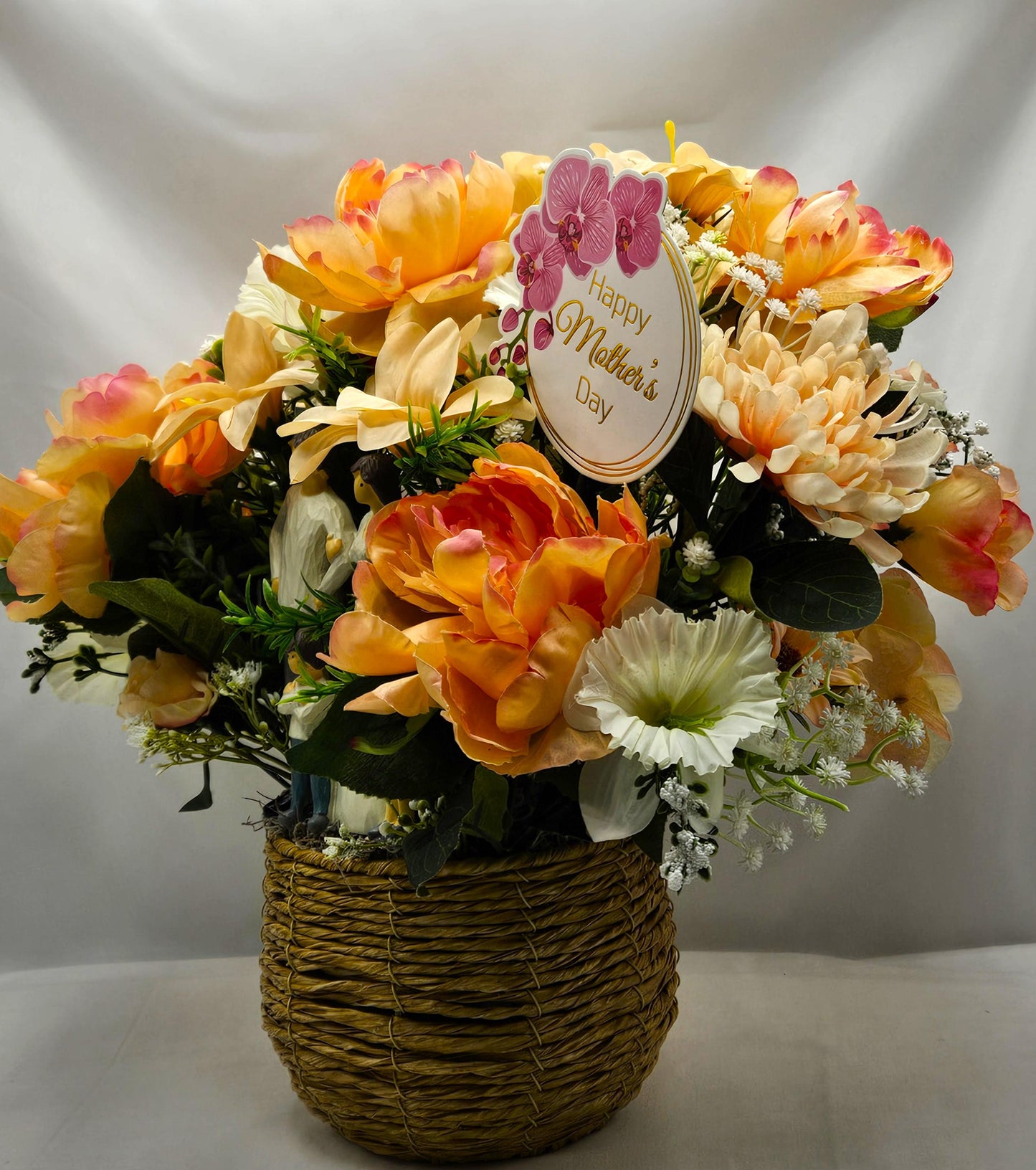 Family of Four Ceramic Figures Amidst Peach/White Flowers in Elegant Round Wicker Basket, Baby's Breath/Greenery/Mother's Day Sign