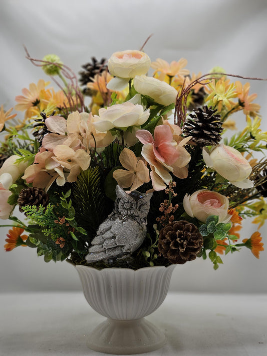 Striking Floral Centerpiece Featuring a Stunning Crystal-Look Majestic Owl Amidst a Garden of Multi-Colored WildflowersGreenery/PineCones