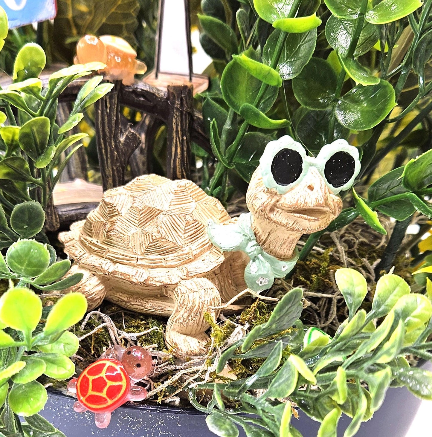 Fun in the Sun Turtle Mania Tropical Flower Arrangement/Turtle in Sunglasses in garden of Teal/Yellow/Green Flowers/Greenery/Bridge
