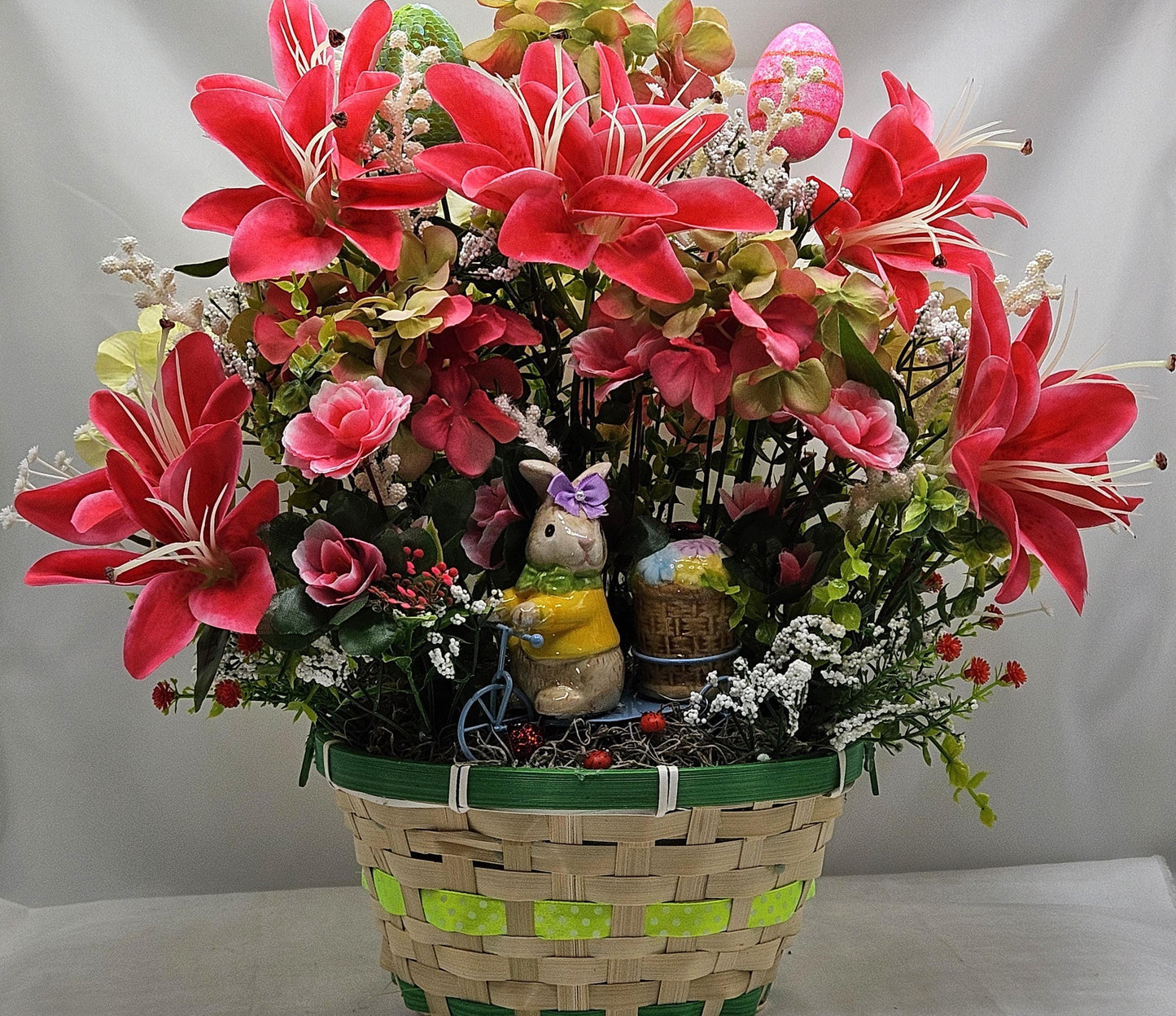Whimsical Easter Basket/Rabbit in Bike Carrying Goodies/Accented W/cute Ladybugs/Hot Pink Lilies/Other florals/pink/green/Greens/Baby Breath