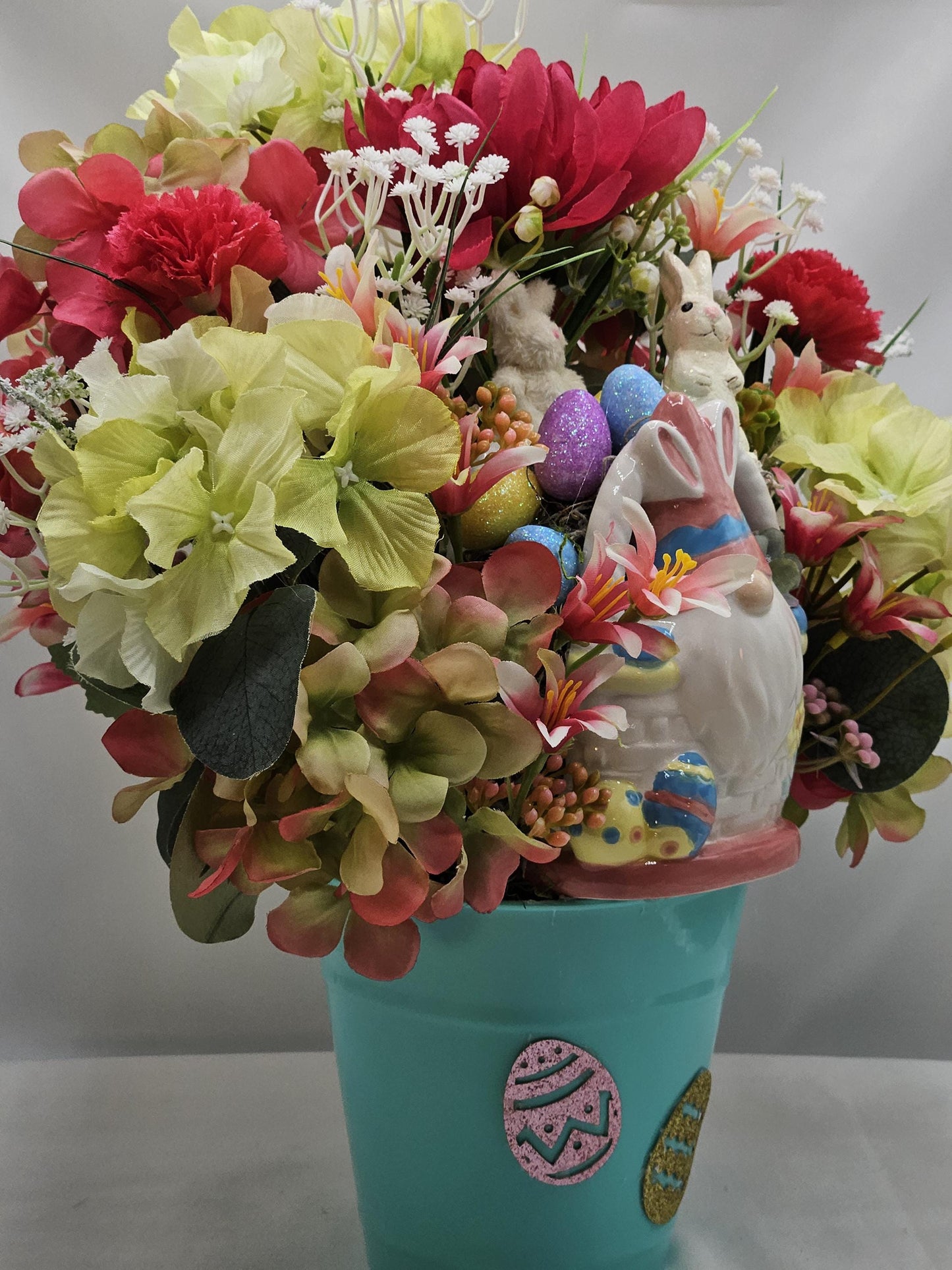 Bunny Gnome in Ceramic Basket within Floral Arrangment of Pink/Green Hydragena, Babys Breath, Easter Eggs, Holiday Accents/Blue Plastic Pail