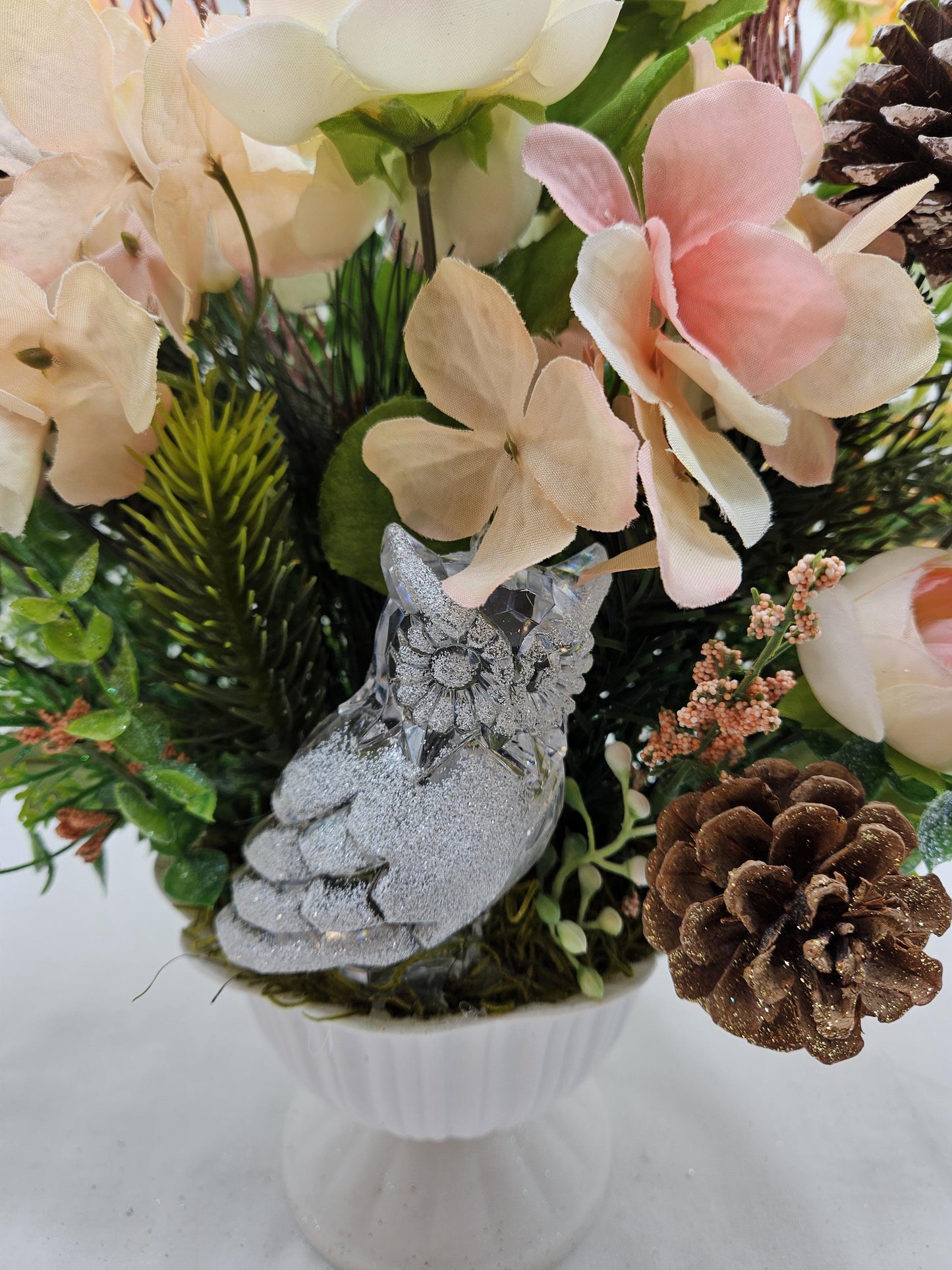 Striking Floral Centerpiece Featuring a Stunning Crystal-Look Majestic Owl Amidst a Garden of Multi-Colored WildflowersGreenery/PineCones