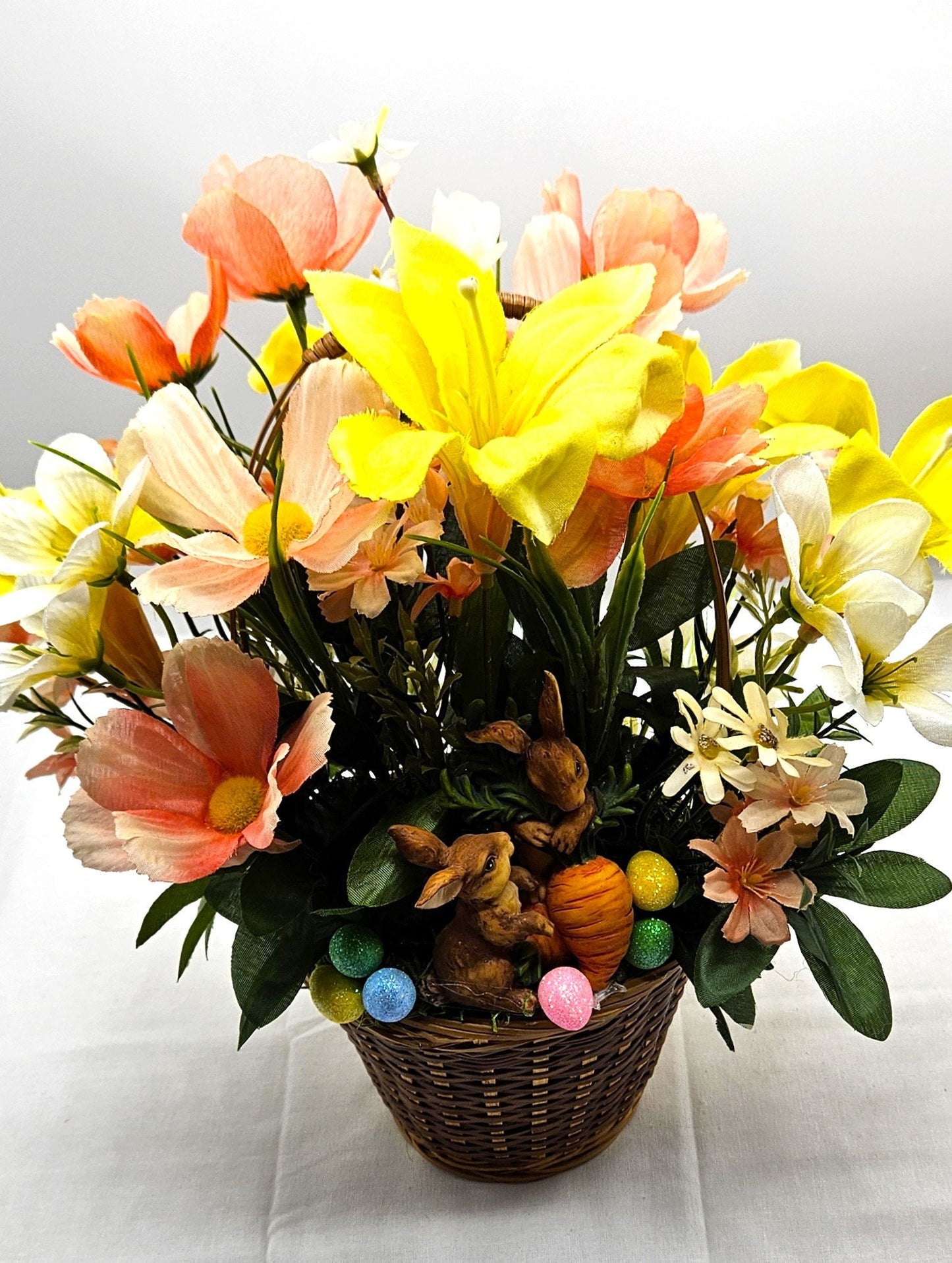 Charming Spring/Summer Flower Arrangement in Wicker Basket with Ceramic Bunnies with Carrot, Glitter, Pastel Flowers