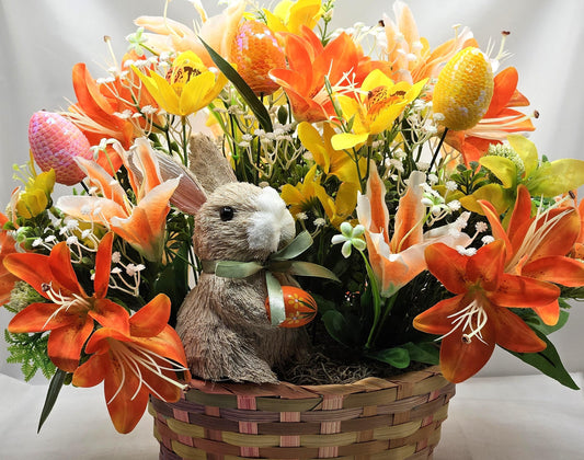 Rattan Easter Bunny in a Multi-colored Basket, Surrounded by Lush and Lovely Lilies, Greens, Baby's Breath,Orange and Yellow Hues