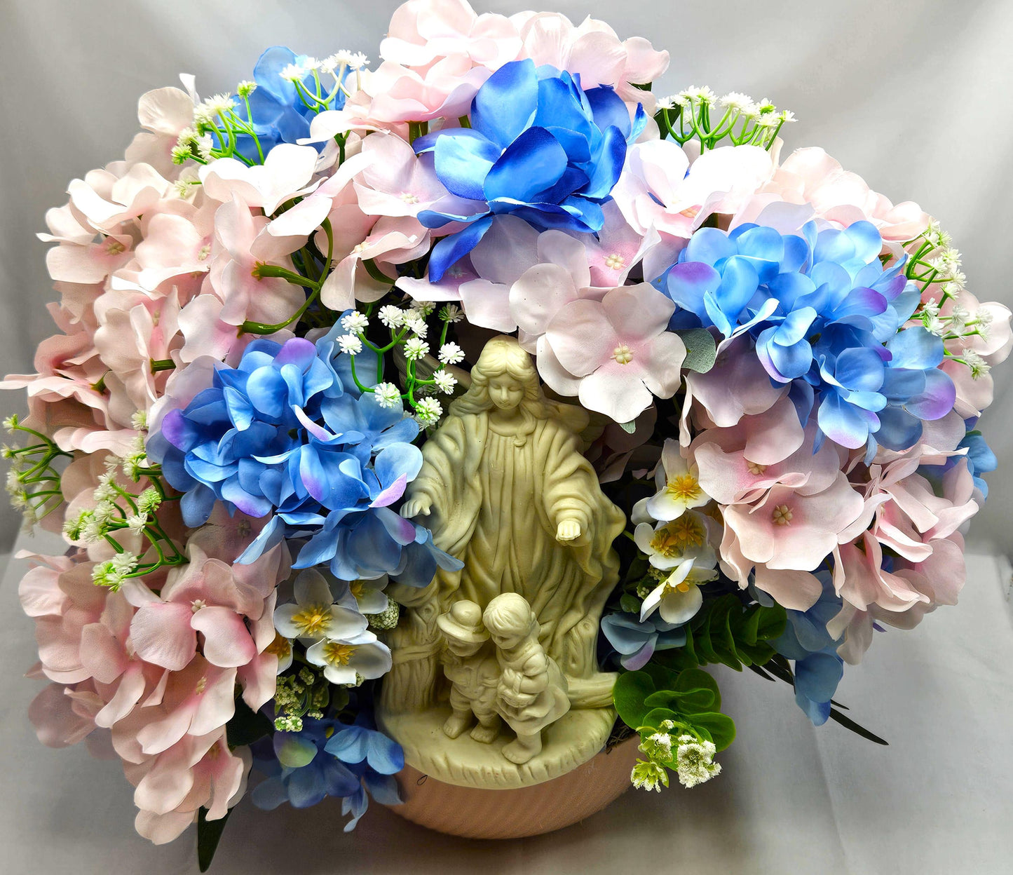 Floral Centerpiece/Guardian Angel With Little Children Amidst A Garden Of Pink And Blue Hydrangea Flowers/Greens/Baby's Breath/Lovely