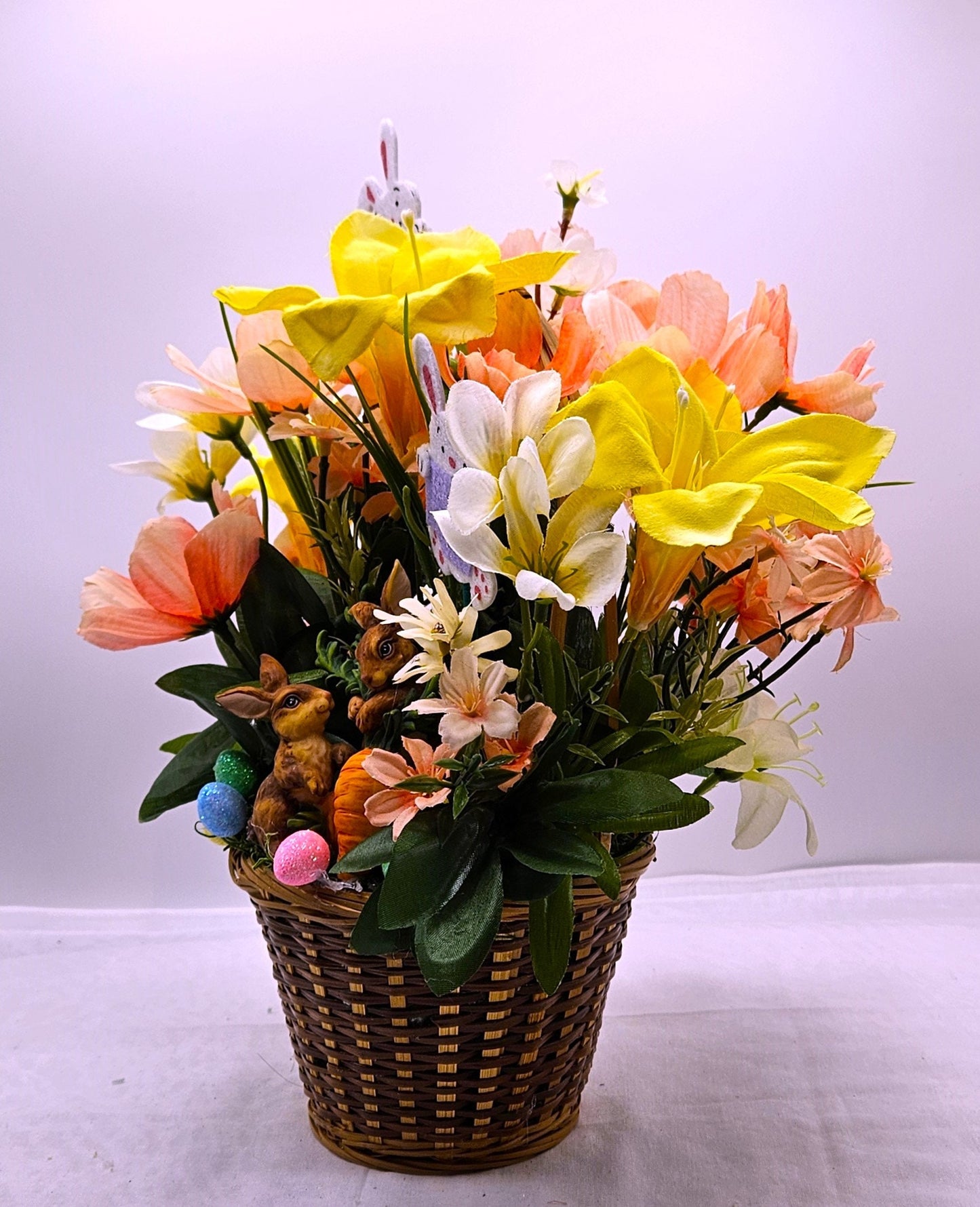 Charming Spring/Summer Flower Arrangement in Wicker Basket with Ceramic Bunnies with Carrot, Glitter, Pastel Flowers