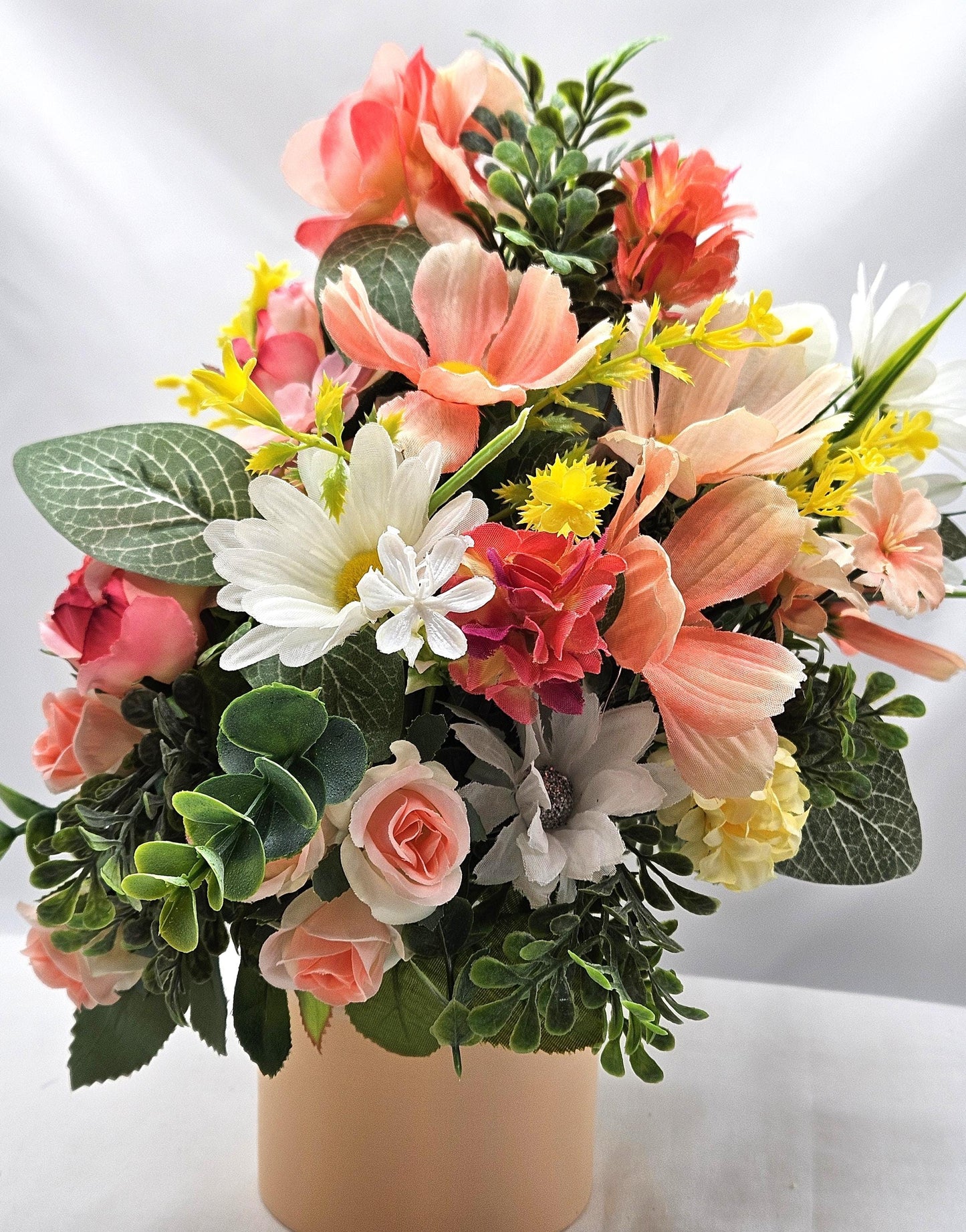 Ceramic Bunnies in a Pink/Peach/Yellow Flower Garden, Lush Greens and Baby's Breath, All Nestled in a Two Tone Ceramic Beige/White Vase